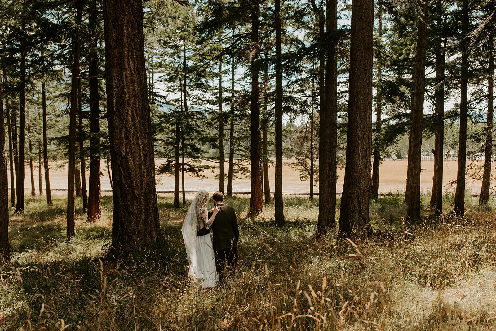 Bride and groom walking through forest trail on Mt. Baker Farm during their Orcas Island elopement.