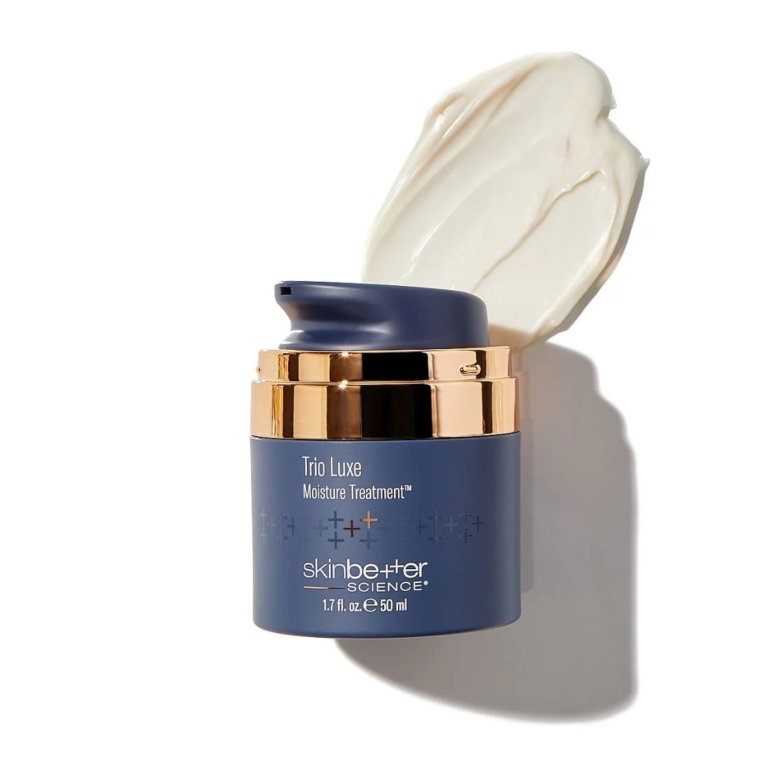 A jar of SkinCeuticals Triple Luxe Moisture Treatment with the lid partially open, revealing the cream inside, on a white background with a shadow.