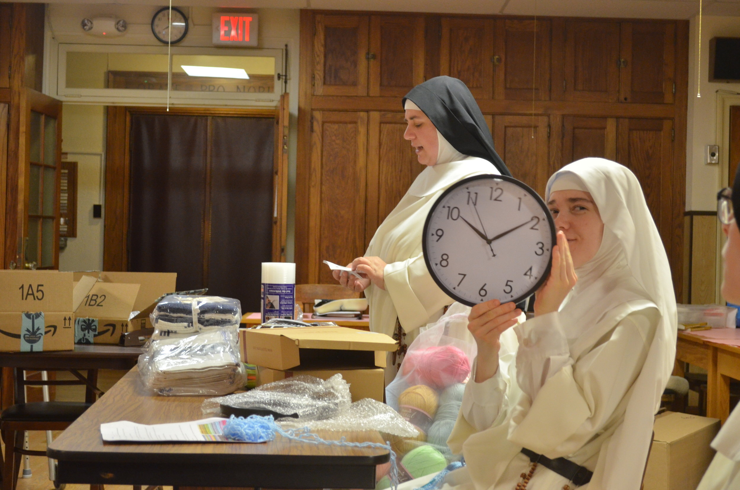 Sr. Lucia Marie shows off one of the clocks
