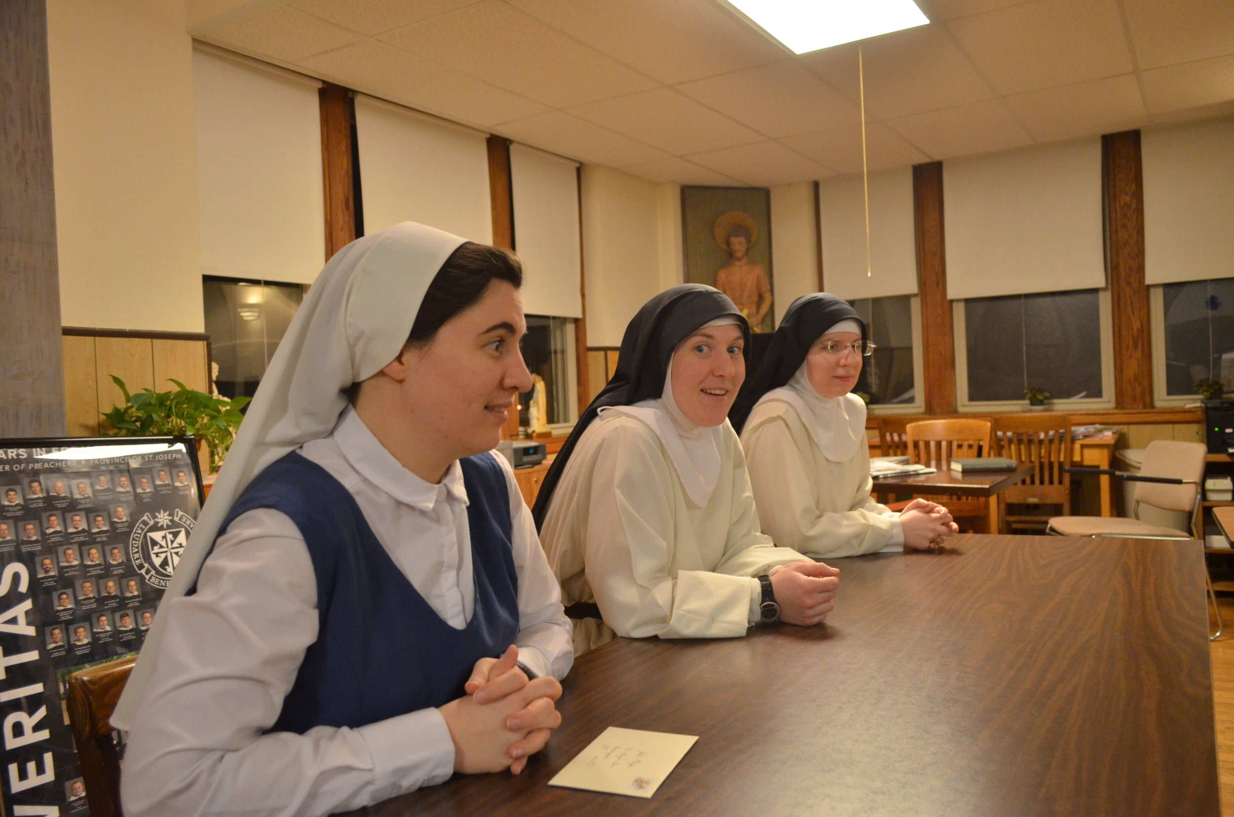 Sr. Lauren, Sr. Mary Magdalene, and Sr. Mary Veronica watch the unboxing