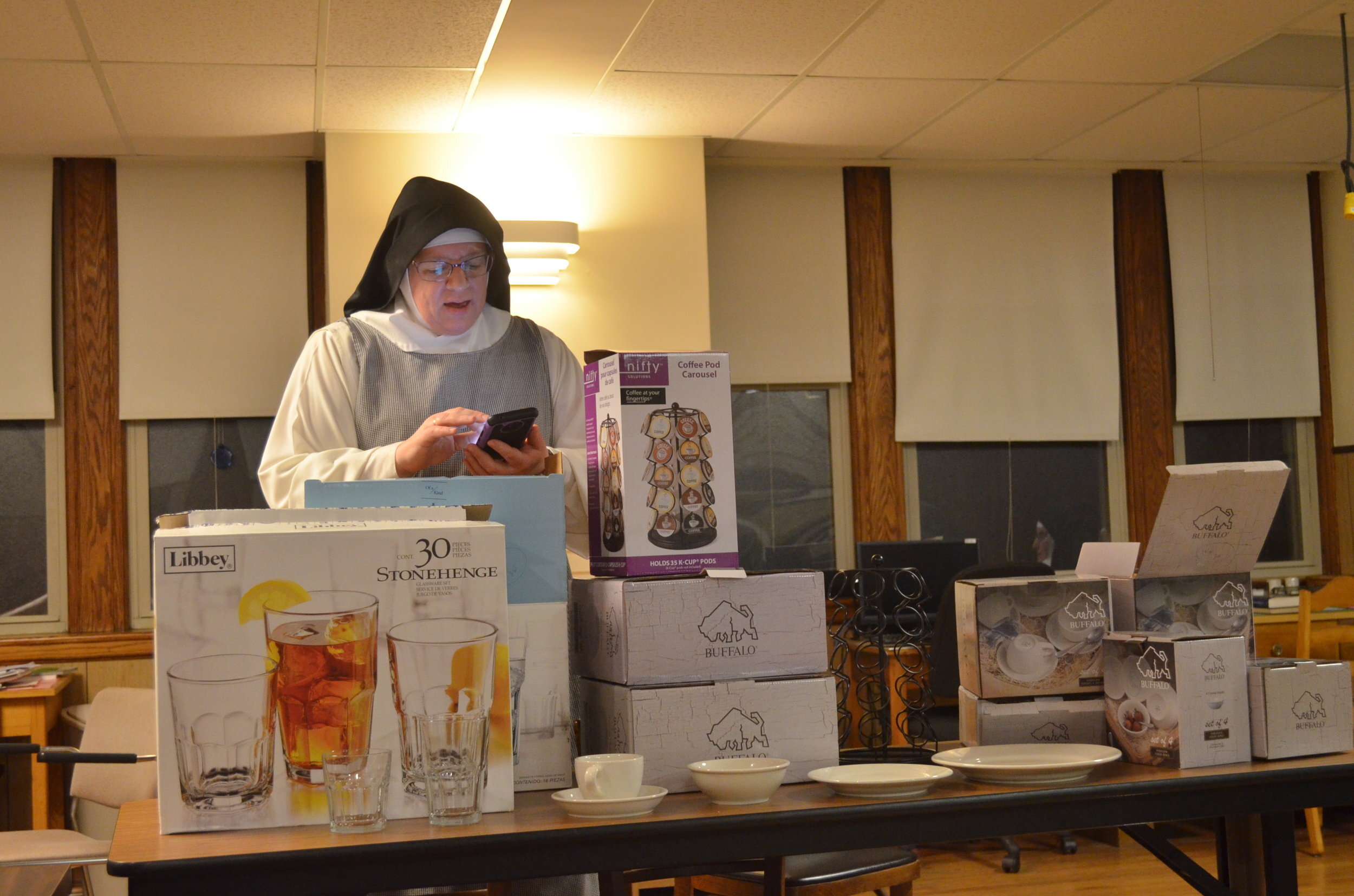 Sr. Judith Miryam reads off the names of the purchasers of the tableware/glassware