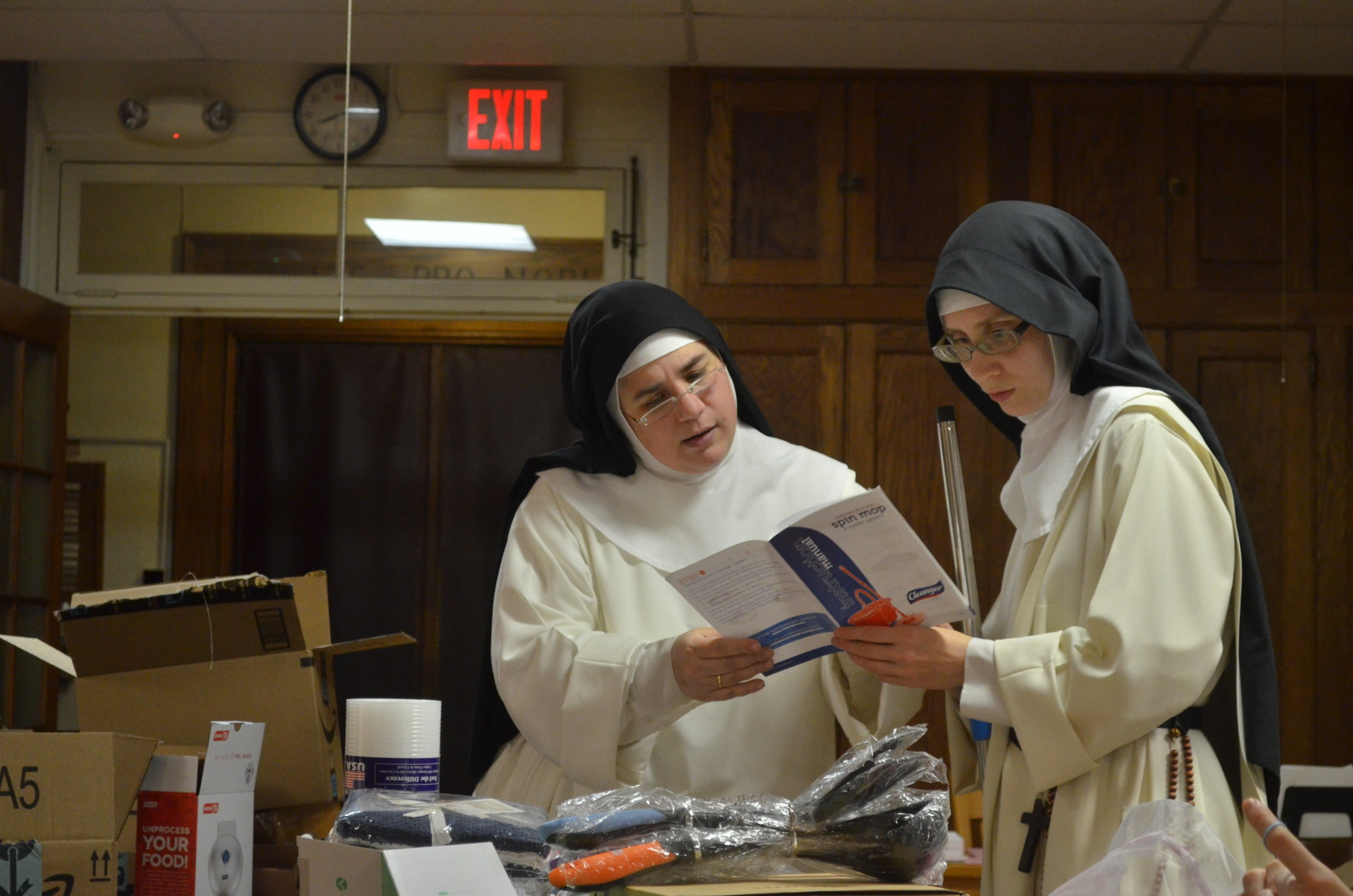 Sr. Mary Catharine and Sr. Maria Johanna study the instructs for the mop