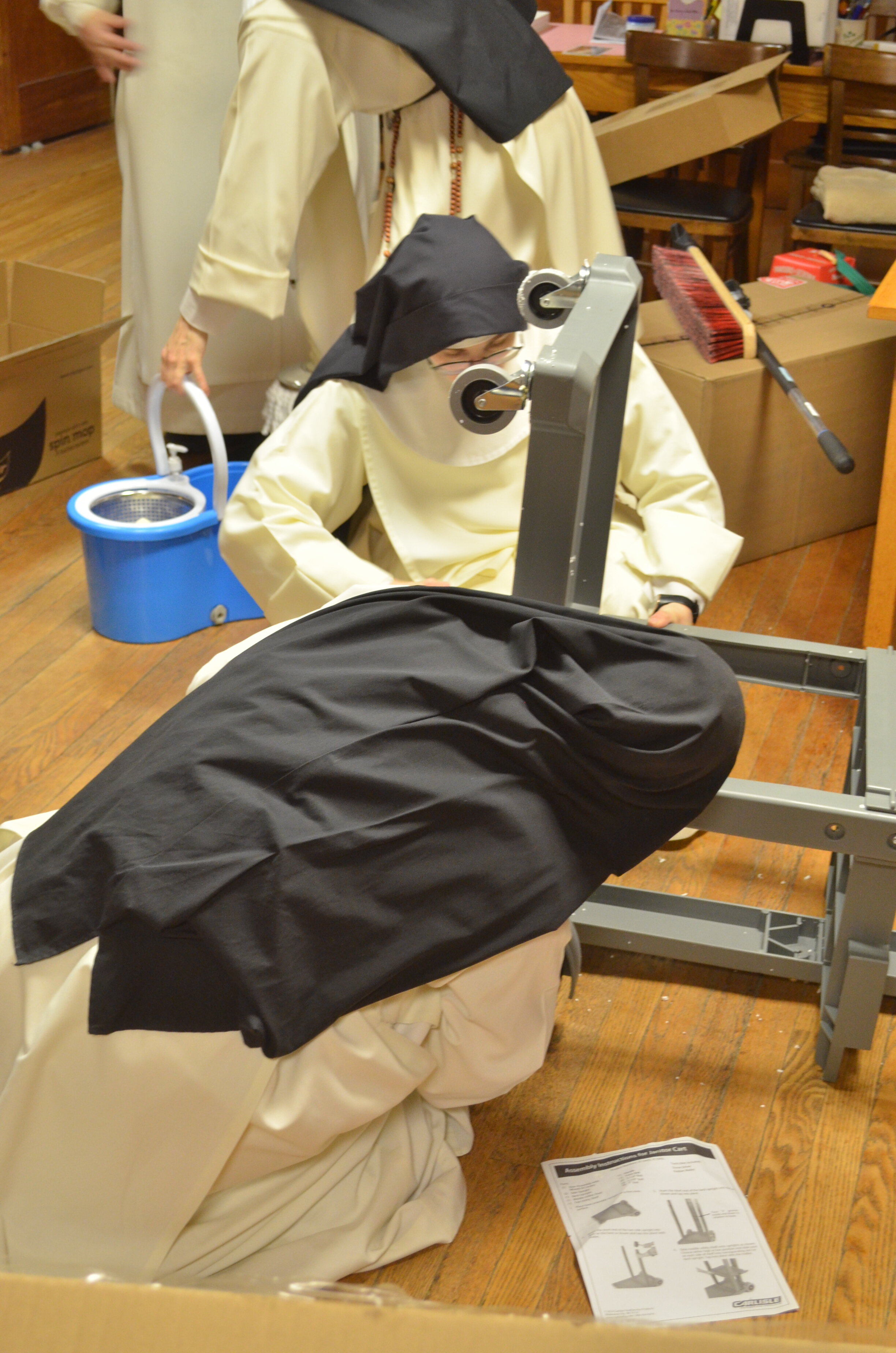 Sr. Mary Magdalene and Sr. Mary Ana putting the cart together