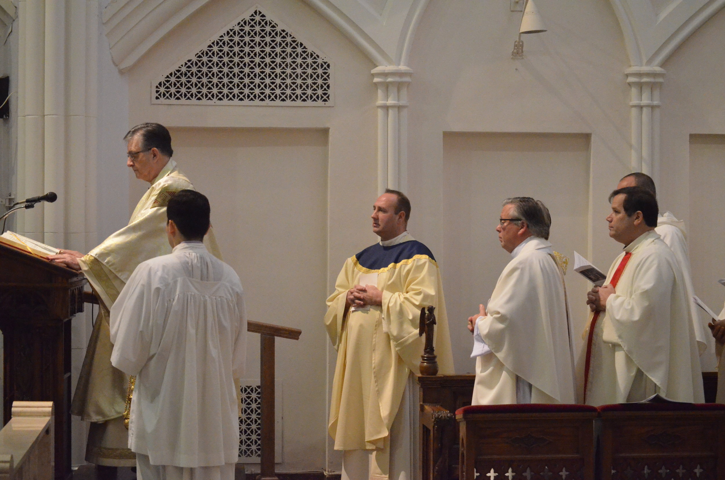 Fr. Gregory Salomone chants the Gospel