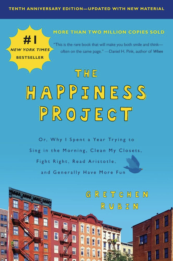 Book cover of 'The Happiness Project' by Gretchen Rubin, celebrating its tenth anniversary edition with new material. The cover features a blue background with yellow text, a yellow starburst with '#1 New York Times Bestseller,' a quote from Daniel H. Pink, and an illustration of a bird flying above a cityscape of colorful buildings.