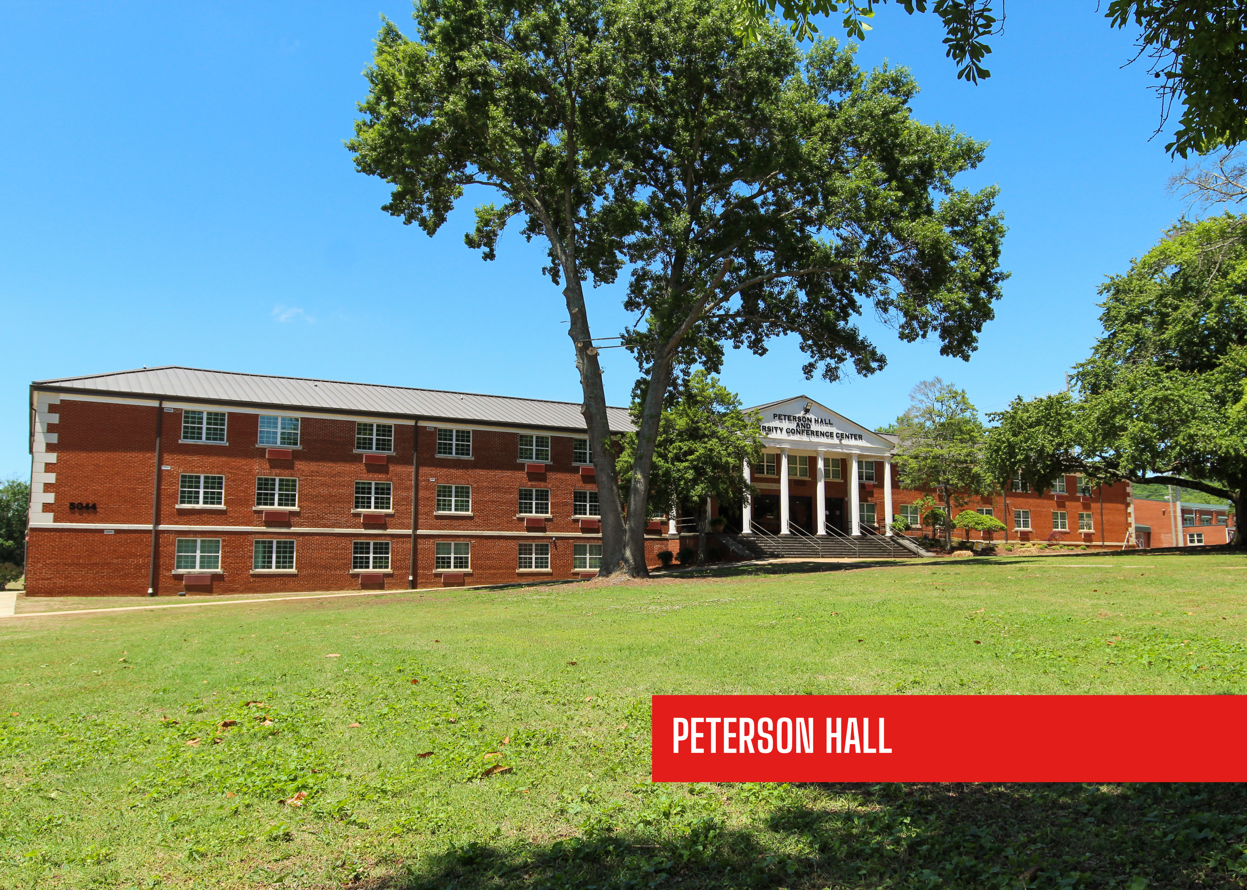A campus building with a large tree in front and a sign that reads "Peterson Hall" in red at the bottom right corner. Historic remodel by  P&C Construction, Inc. - Chattanooga, Tn.