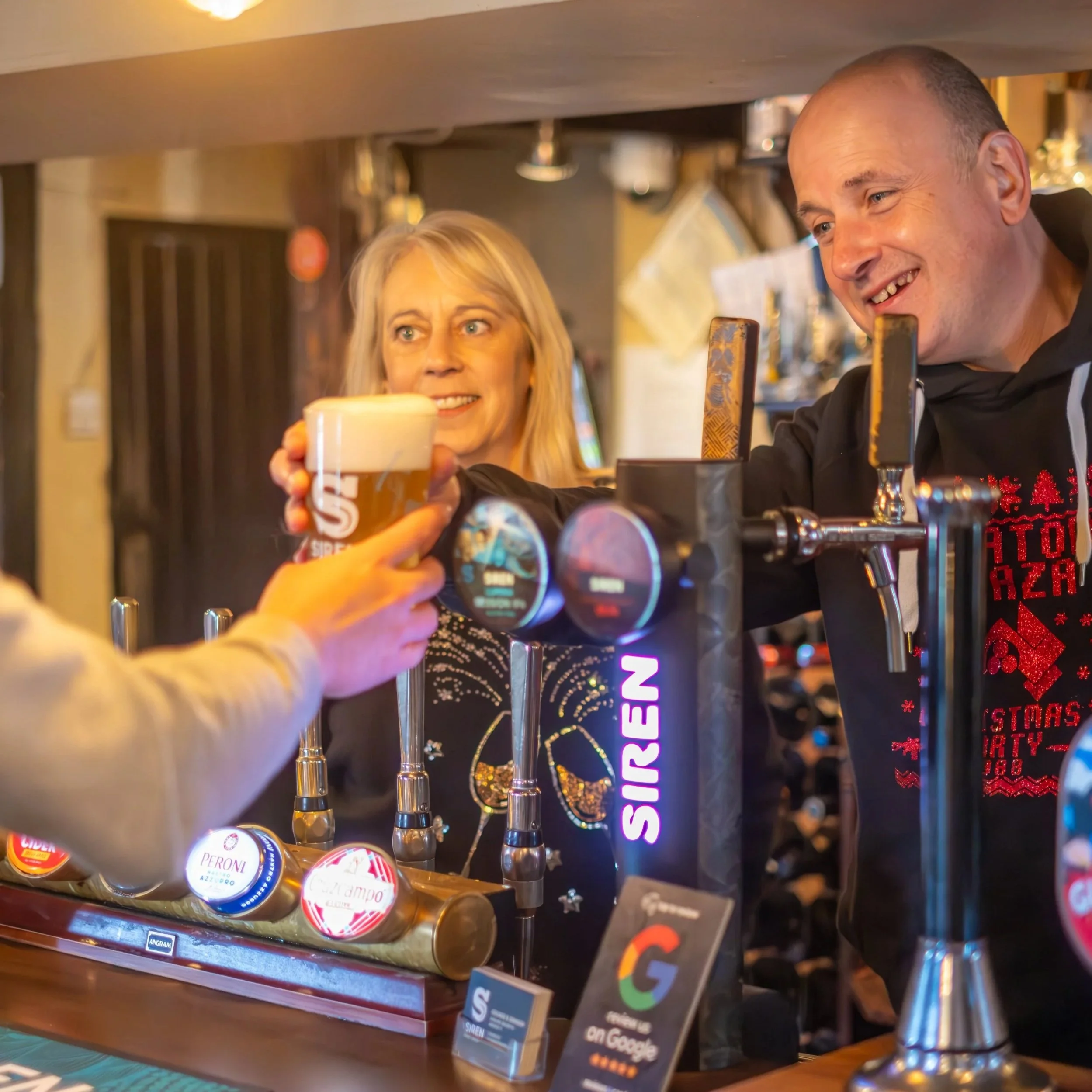 Darron and Jo, the founders of Siren Craft Brew serving a pint at the George & Dragon.