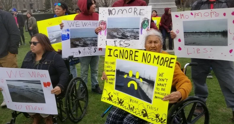 Members of Kashechewan First Nation hold protest signs outside Queen's Park in Toronto on April 29, 2019. (Alastair Sharp)