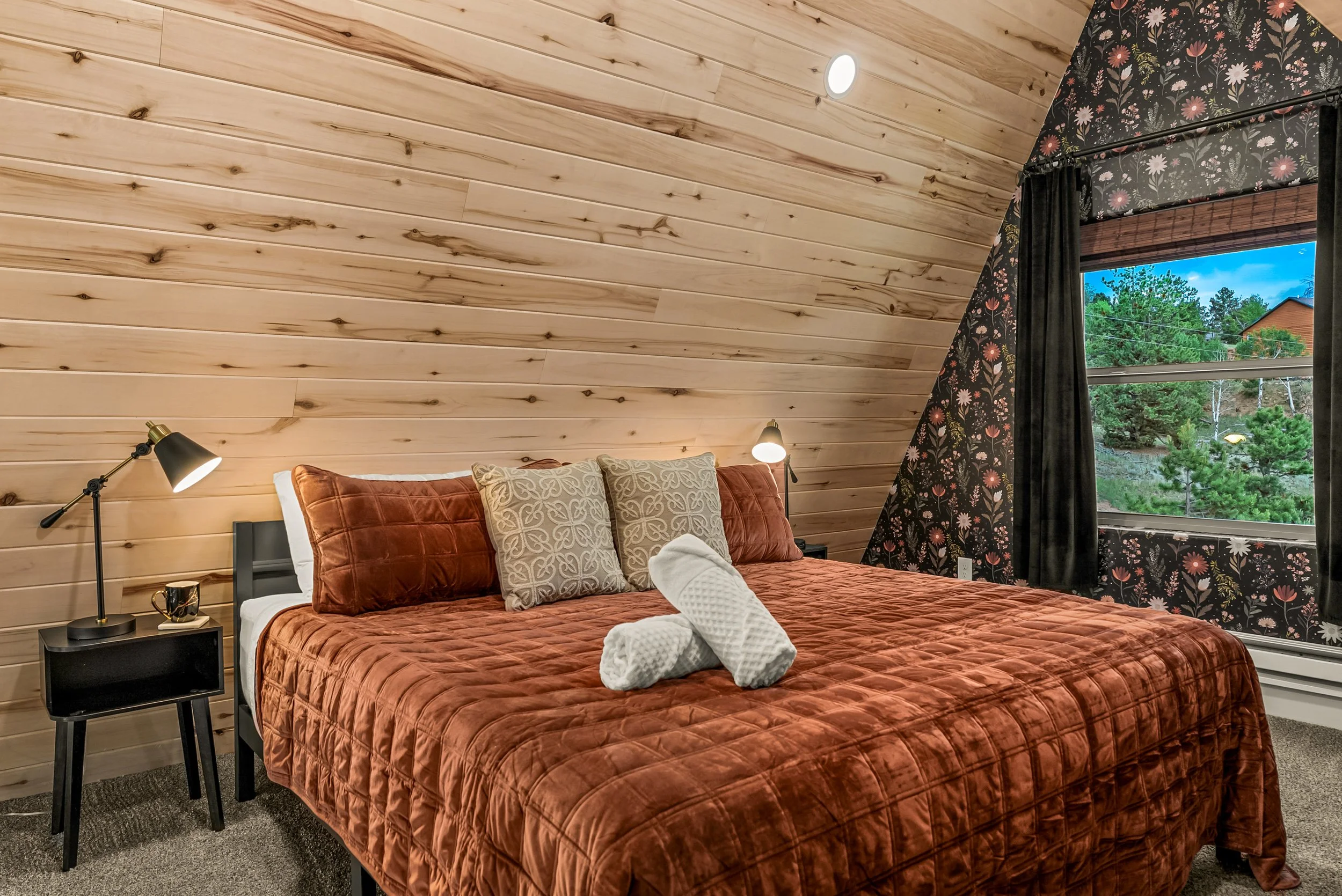 Cozy bedroom with wood panelling giving the home character