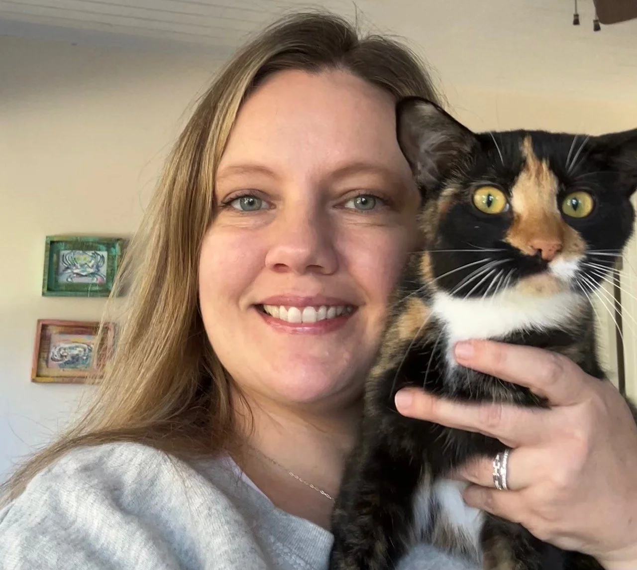 Woman holding a calico cat
