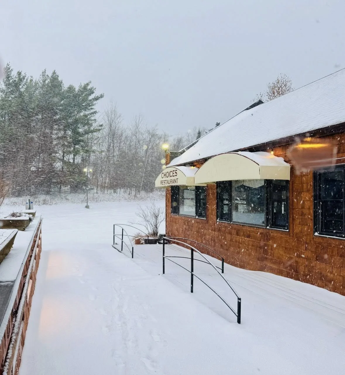 Snow covered walkway holiday glowing lights restaurant