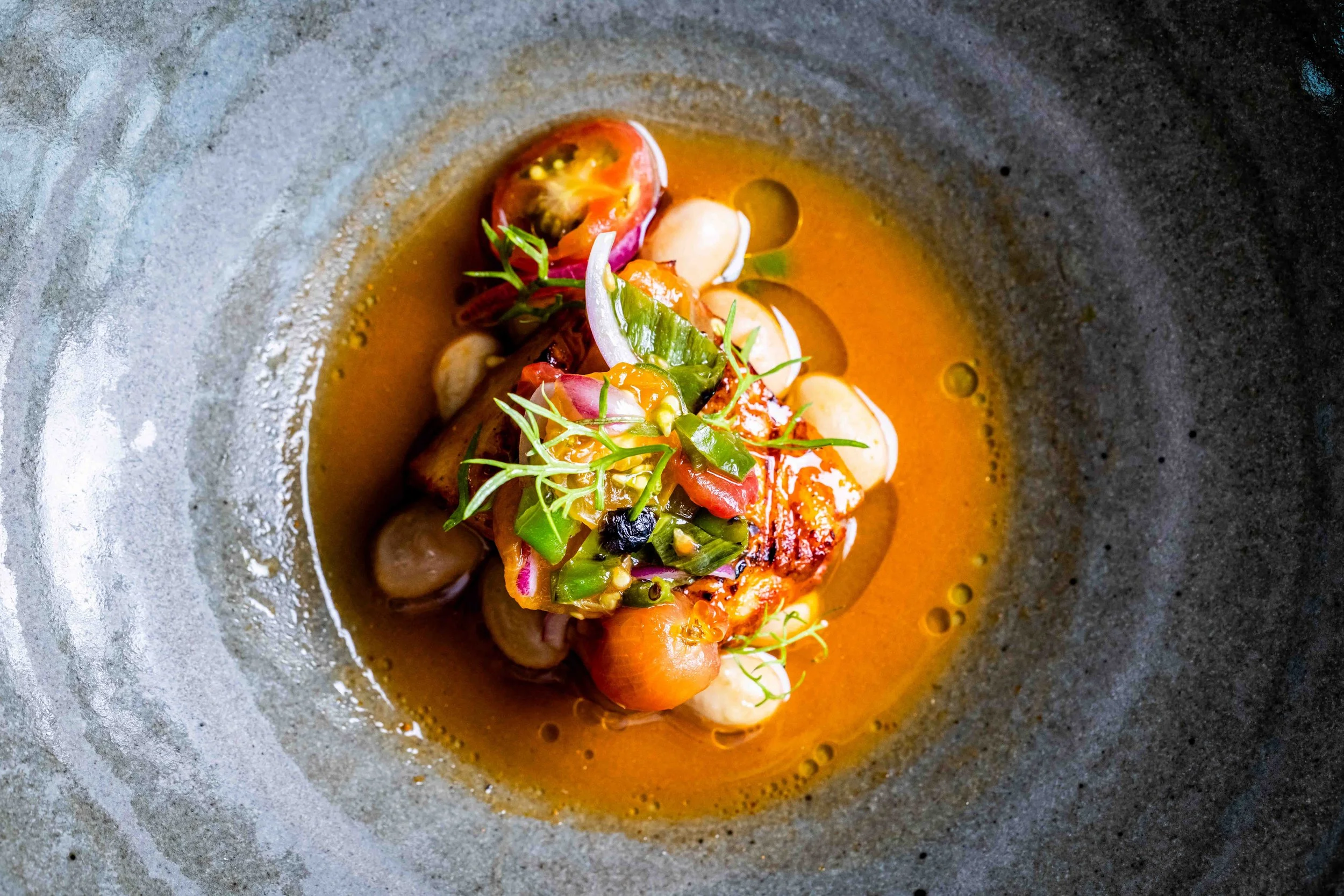 sun gold tomato dish with broth