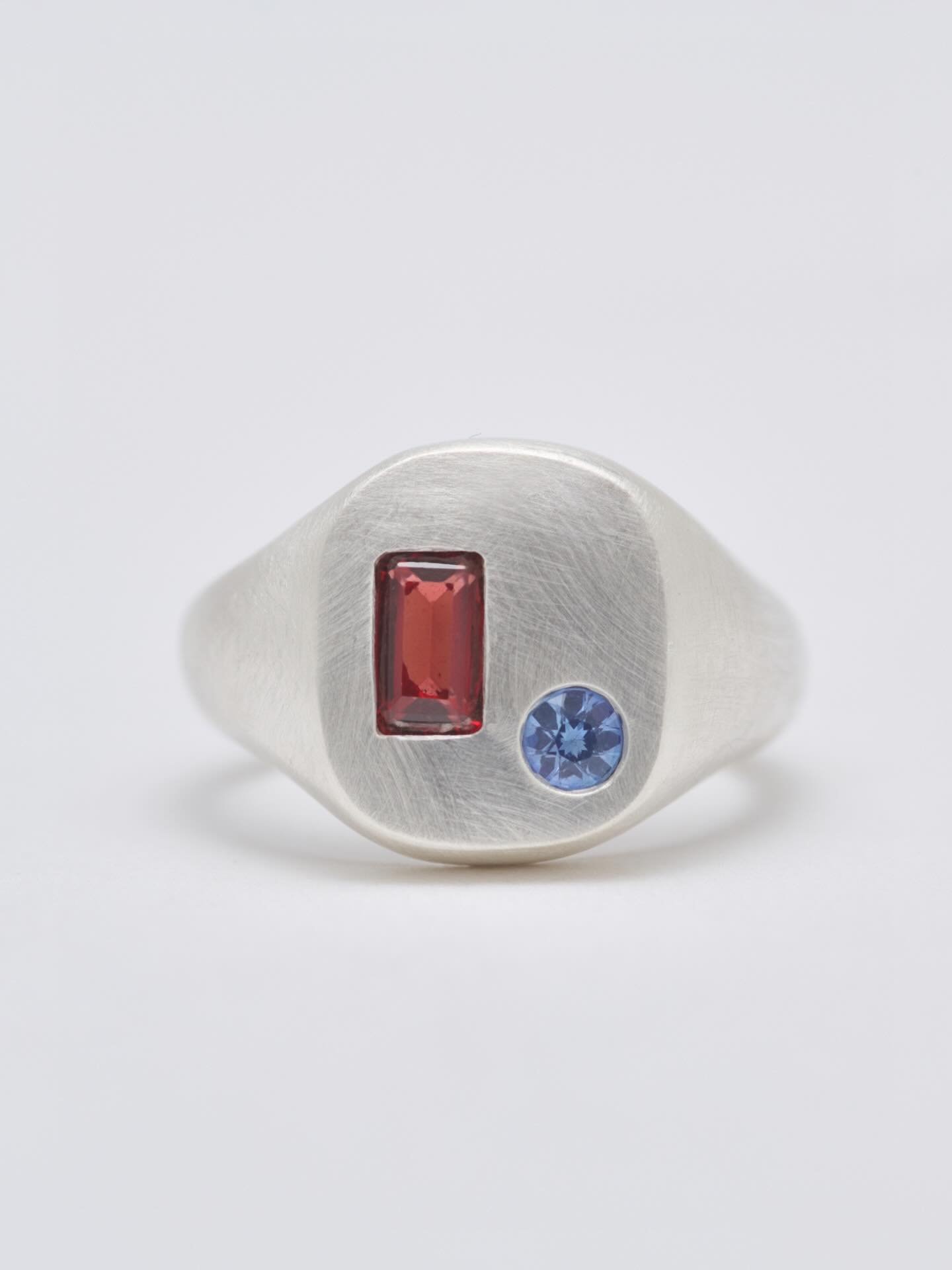 The Eva signet, warm garnet and cool sapphire  in some buttery brushed silver. 
This one sold, but I&rsquo;d love to make a variation of this piece again