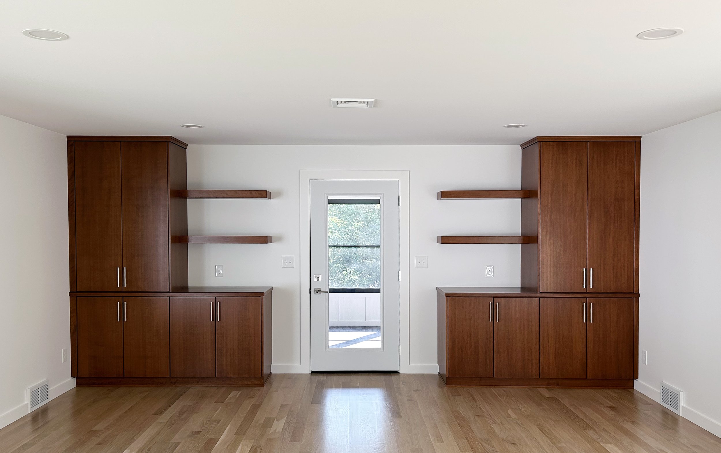 This built in extends to the living room area continuing the cherry wood and flat slab door from the kitchen.