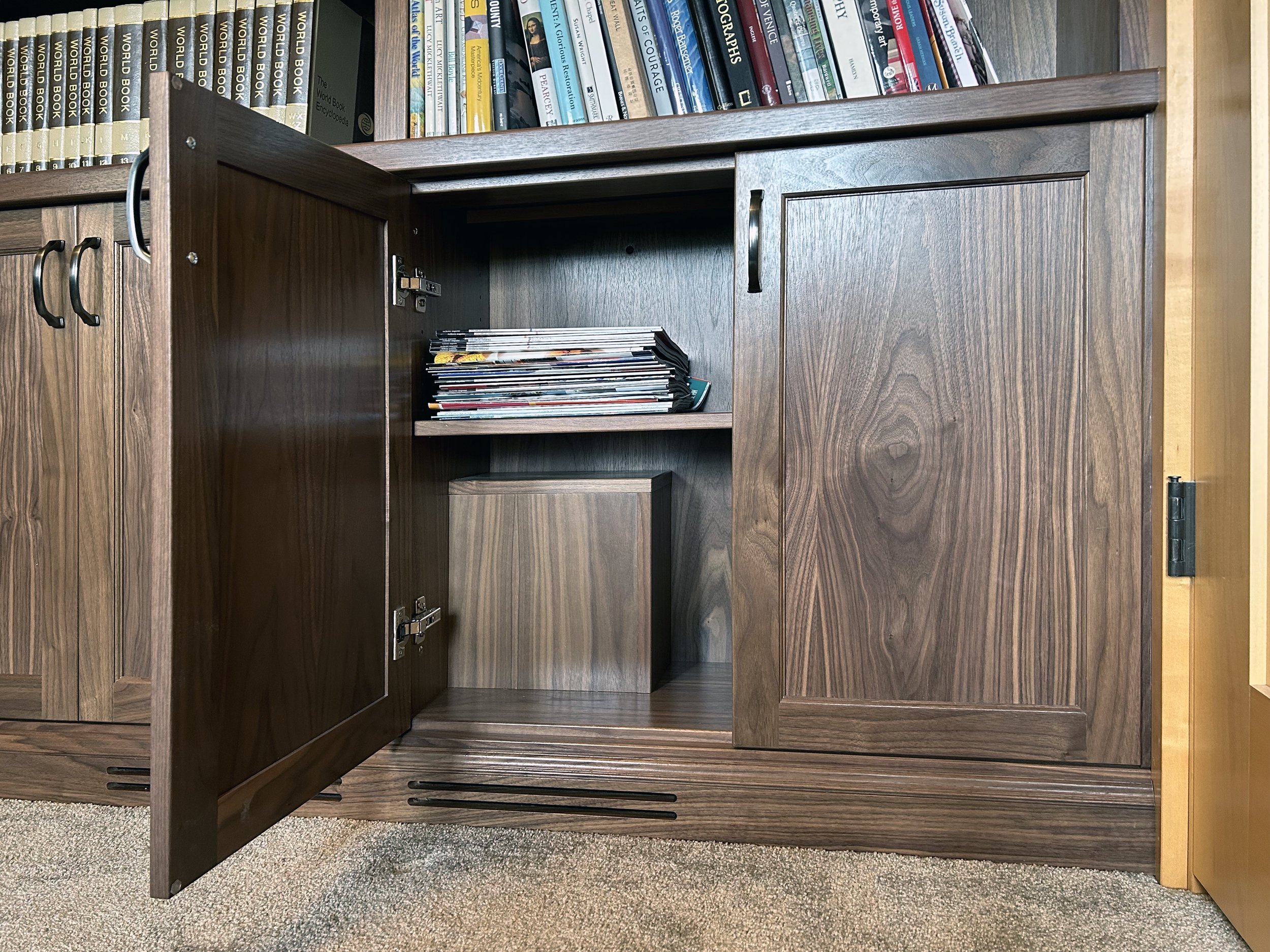π This is a beautiful walnut built in bookshelf that spans the entire wall. π The homeowners now have the perfect place to show off their amazing book collection! They even have a little room for storage underneath! Congrats to them on this well de