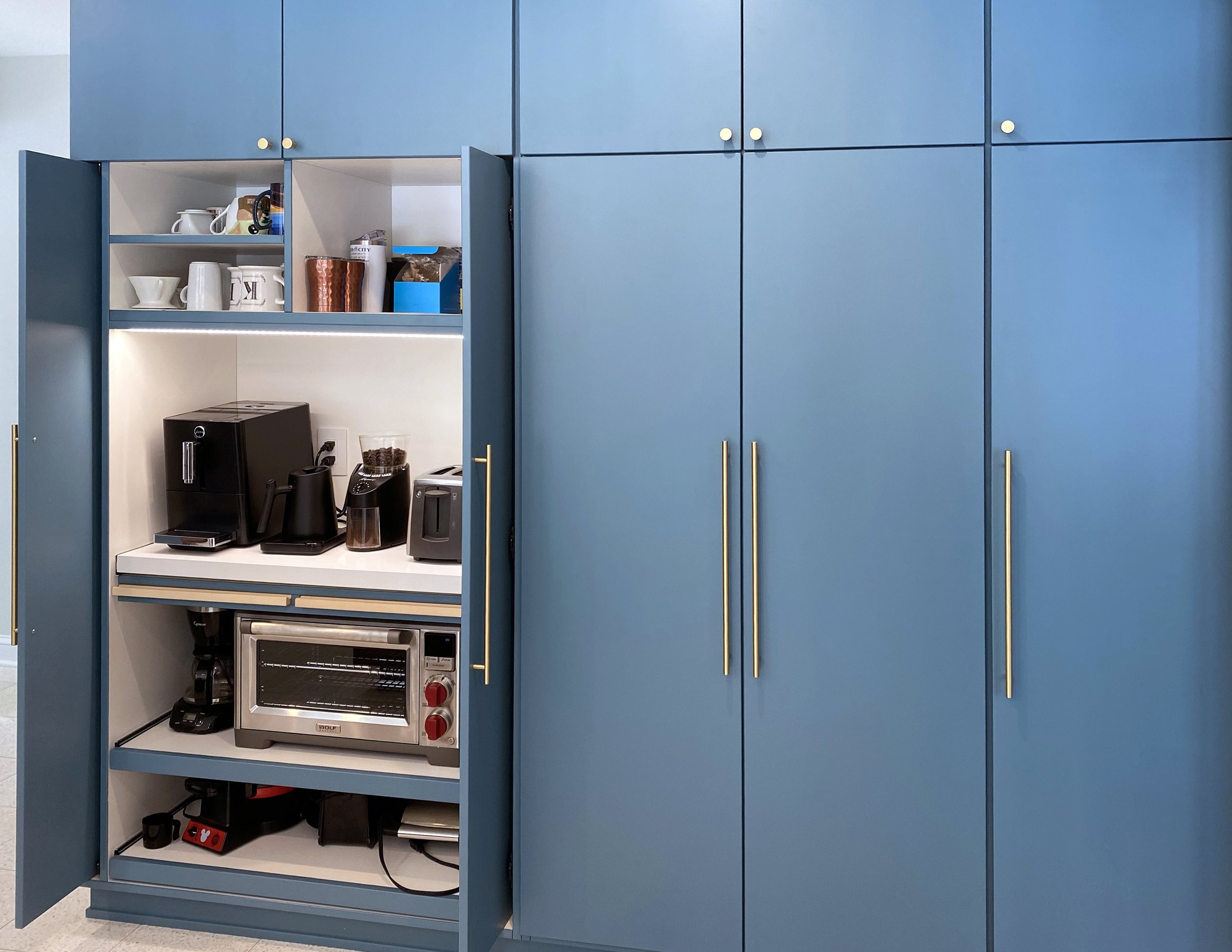 Mid century modern kitchen with horizontal grain natural walnut and slab doors. Painted pantry.