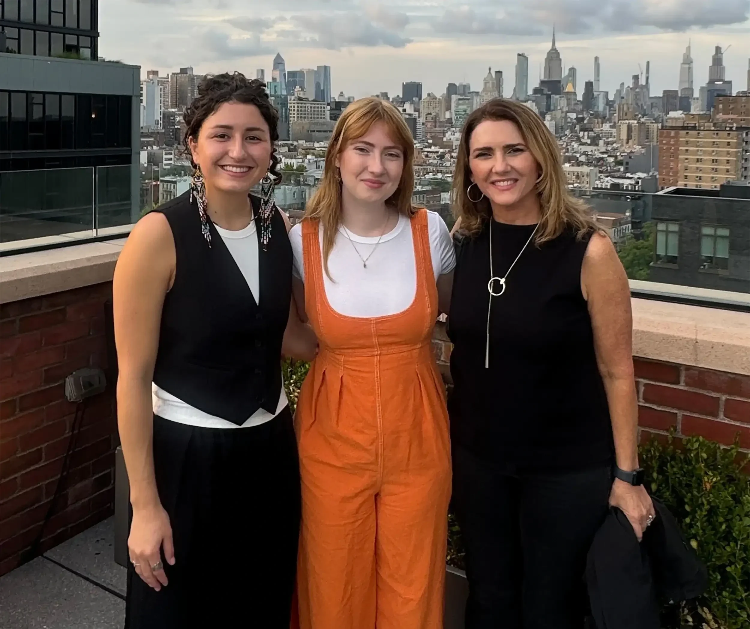 Design Powers team in NYC on rooftop with city skyline