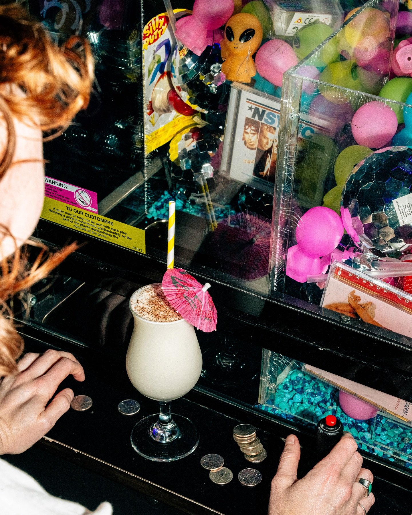 One quarter away from a prize, one sip away from paradise. Cocktails and vintage arcade games make for a winning night.🍹🎮 #GameOn #CocktailsAndClaws #ArcadeVibes