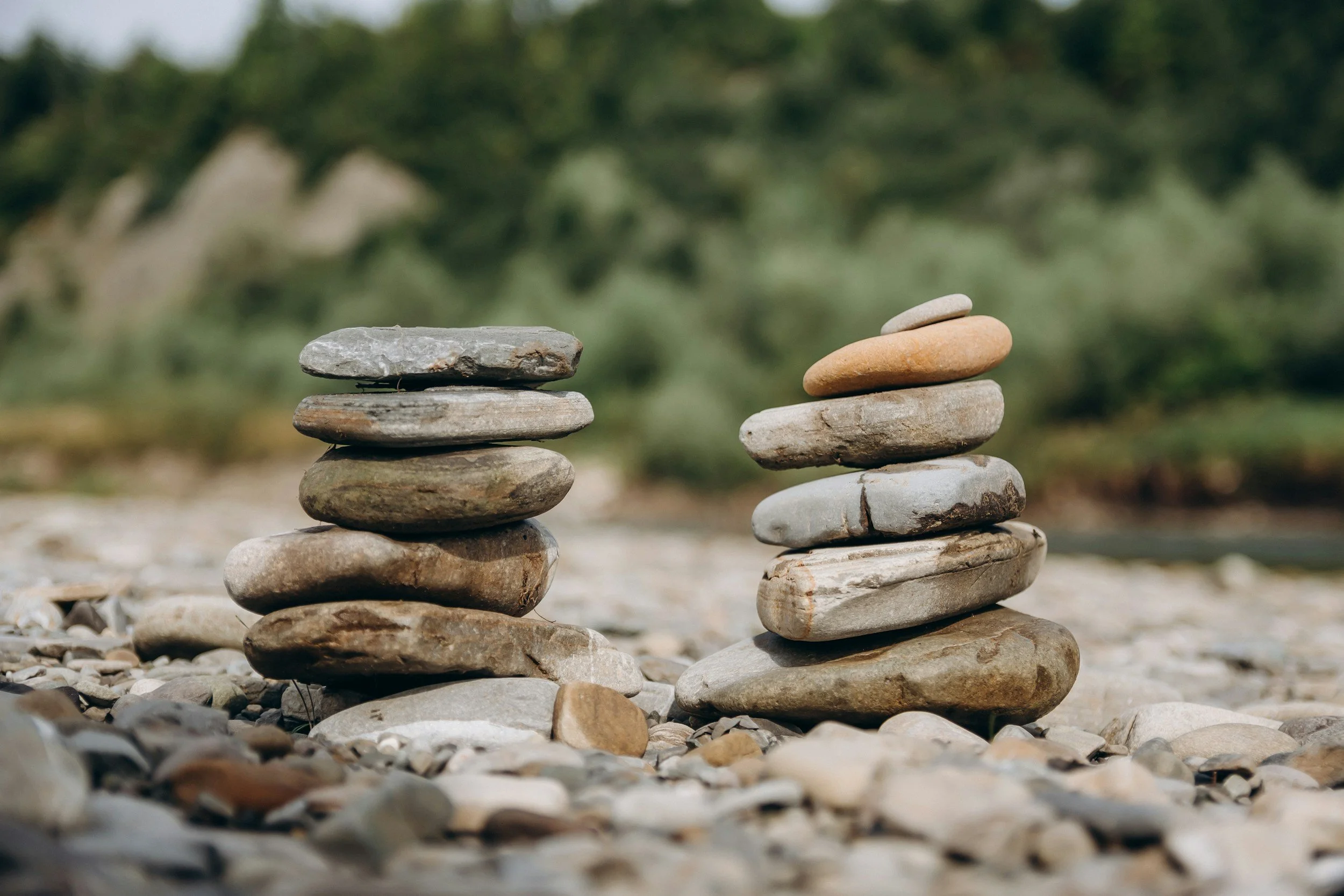 Stacked stones balanced in two small piles, symbolizing the ongoing effort to create fairness, balance, and shared responsibility in a relationship.