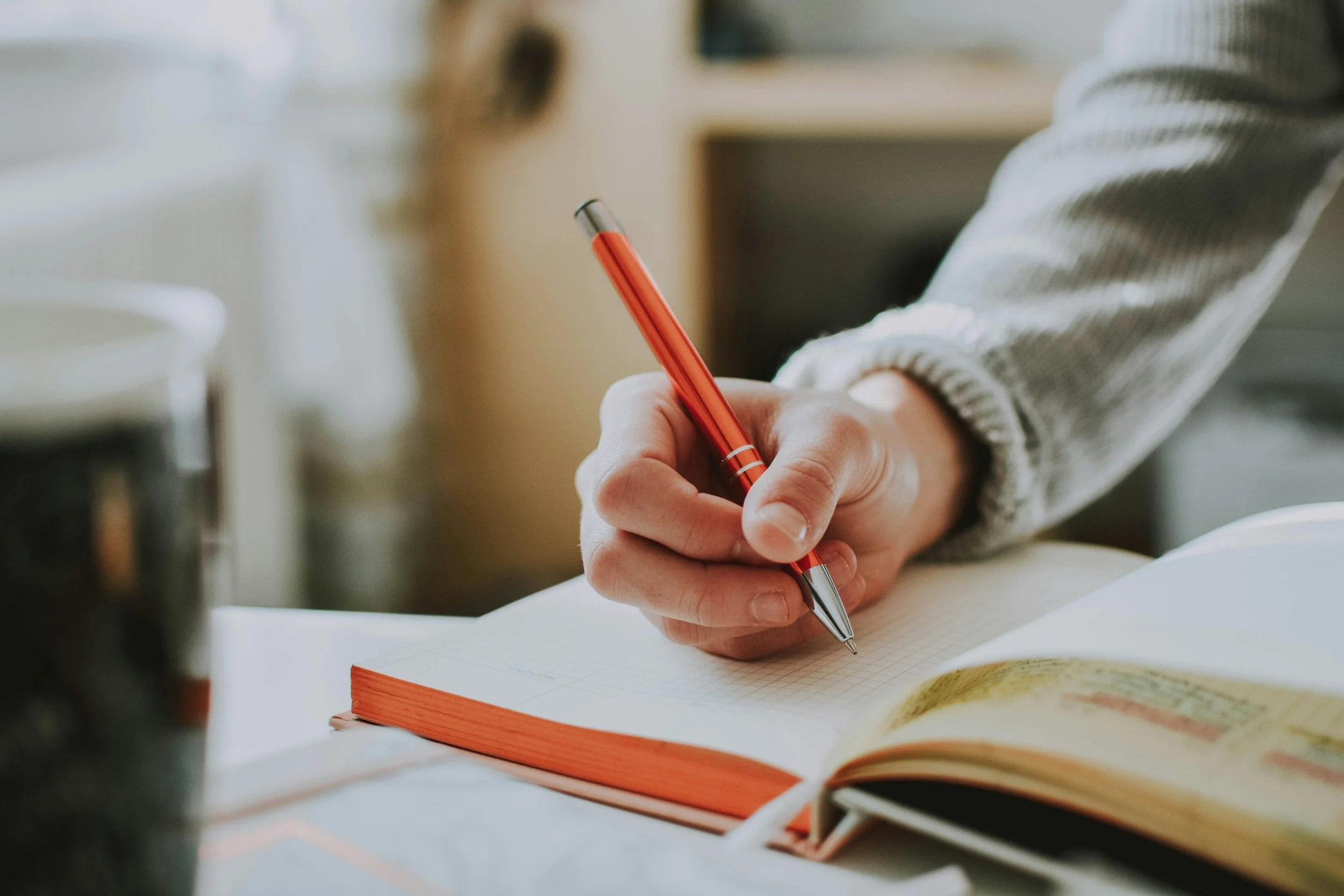 Person journaling to identify and observe difficult emotions, a helpful emotion regulation skill for managing emotional pain and anxiety.