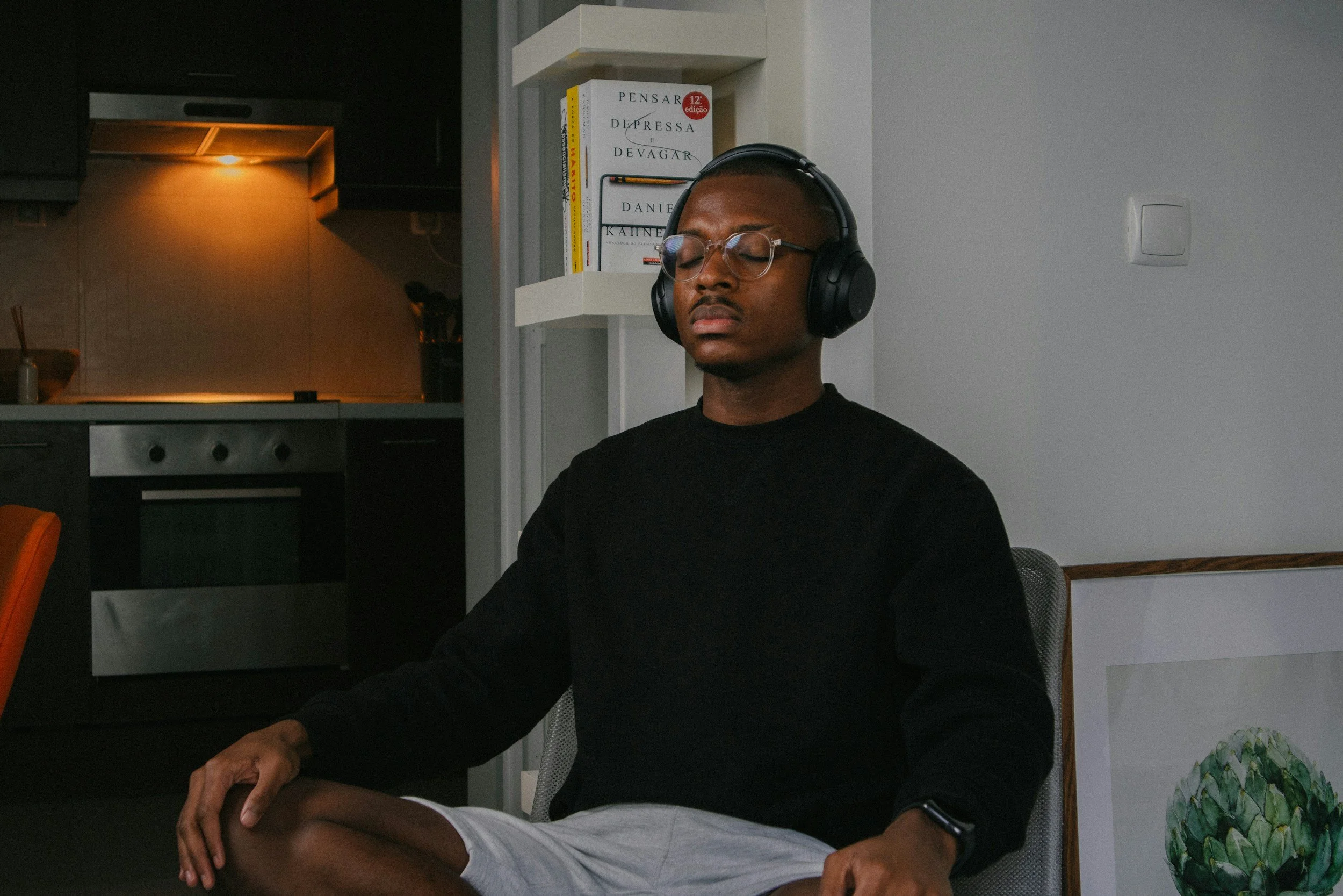 Person sitting quietly and practicing mindfulness to manage emotional pain and difficult emotions.