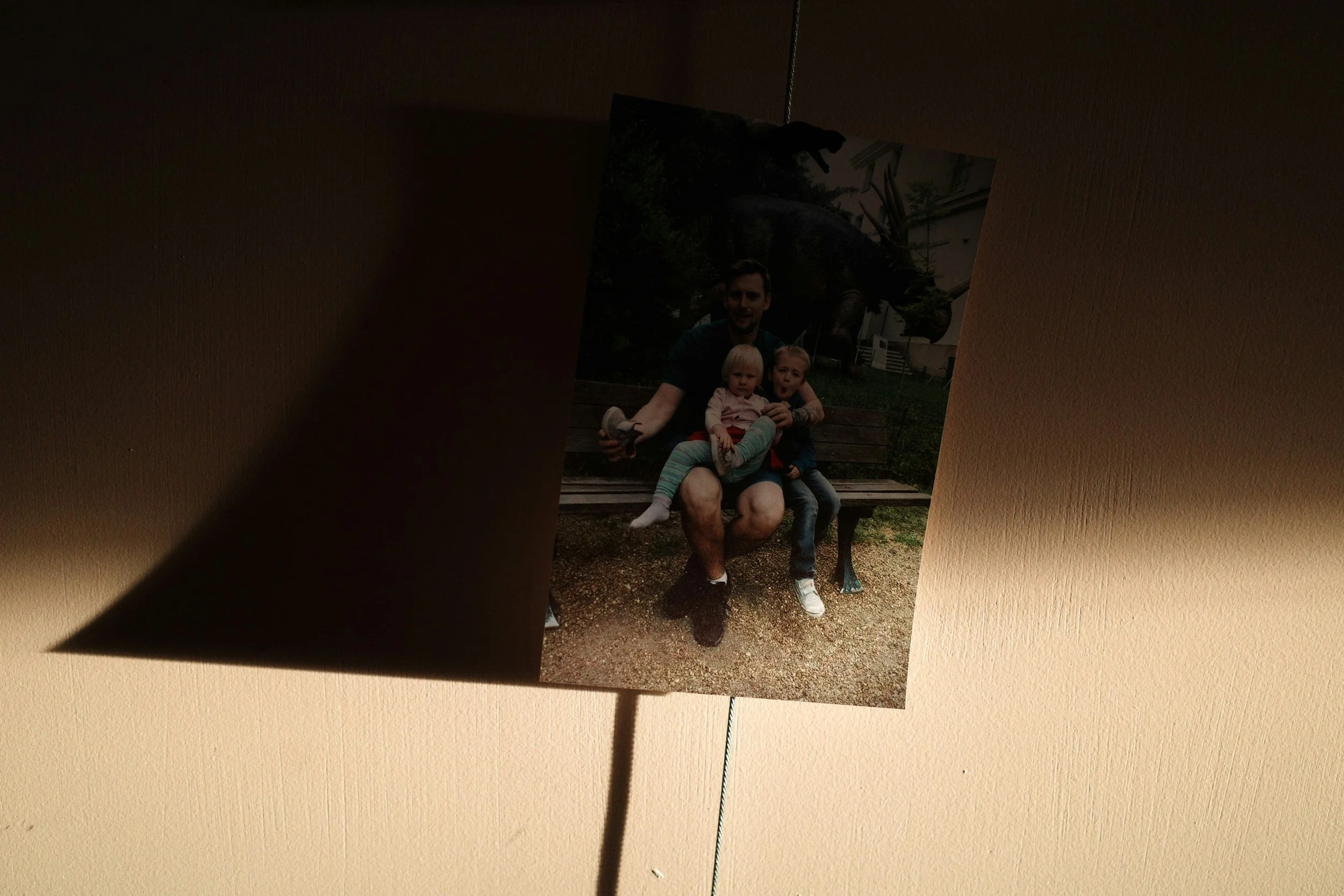 A childhood family photo displayed in warm light, representing how early family roles, relationship patterns, and emotional experiences can continue into adulthood.
