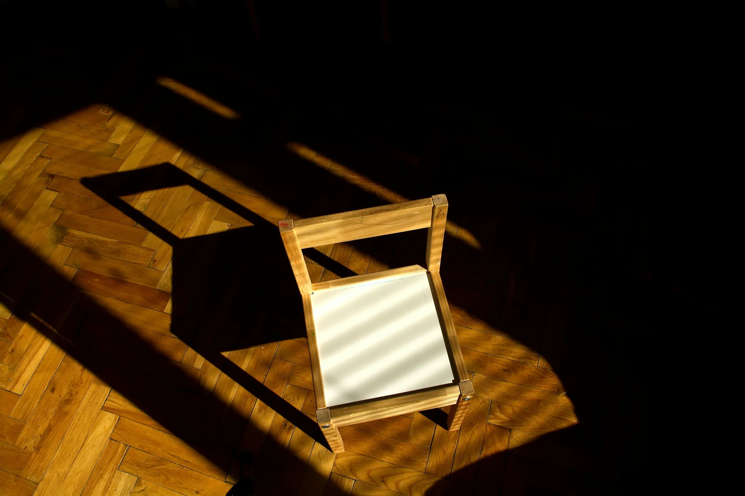 An empty chair in warm light, symbolizing taking space, setting healthy family boundaries, and protecting your mental health when family relationships become overwhelming.