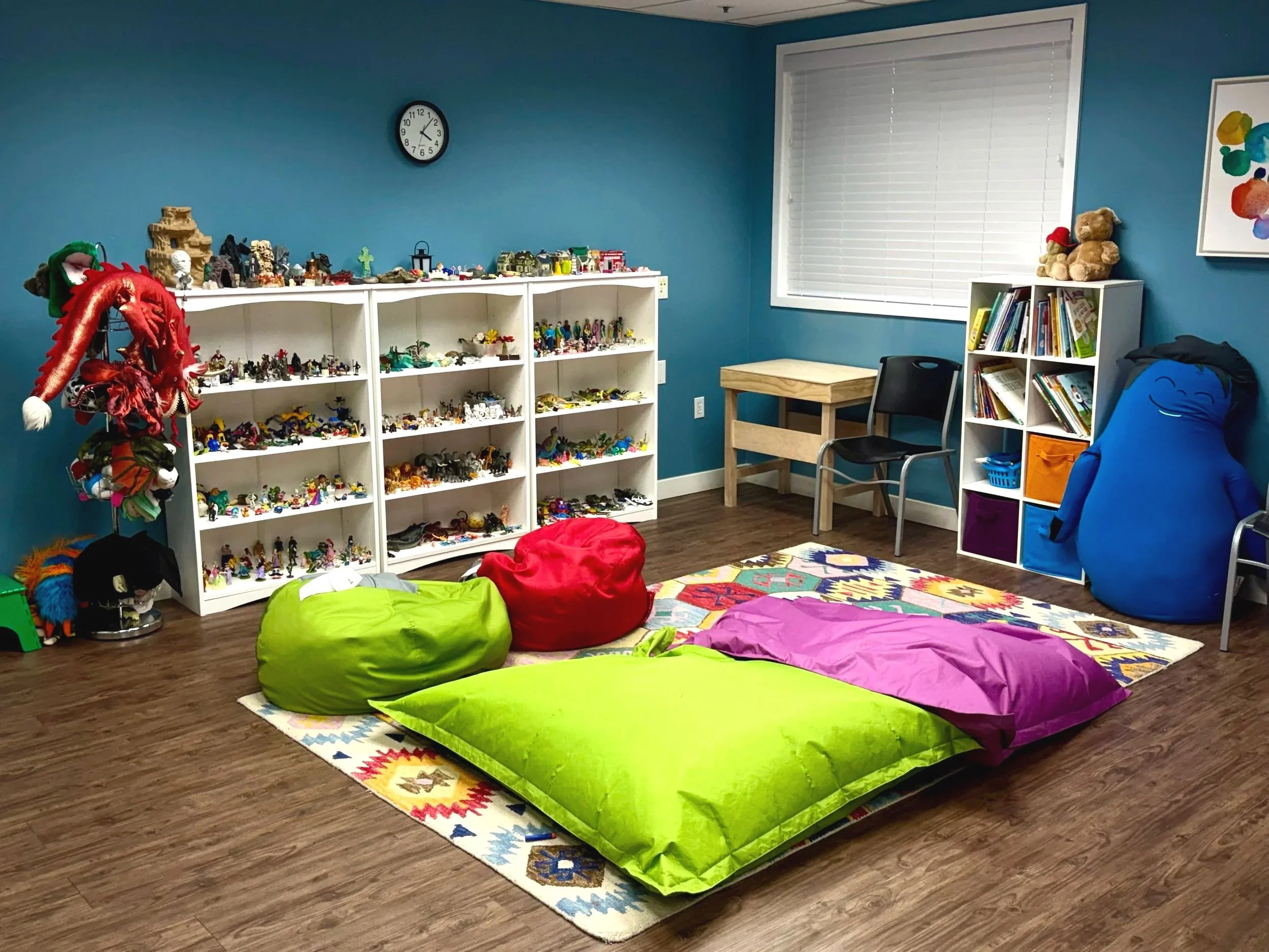 One of Wasatch Family Therapy's play therapy rooms filled with toys, bean bags, books, crafts, and more.