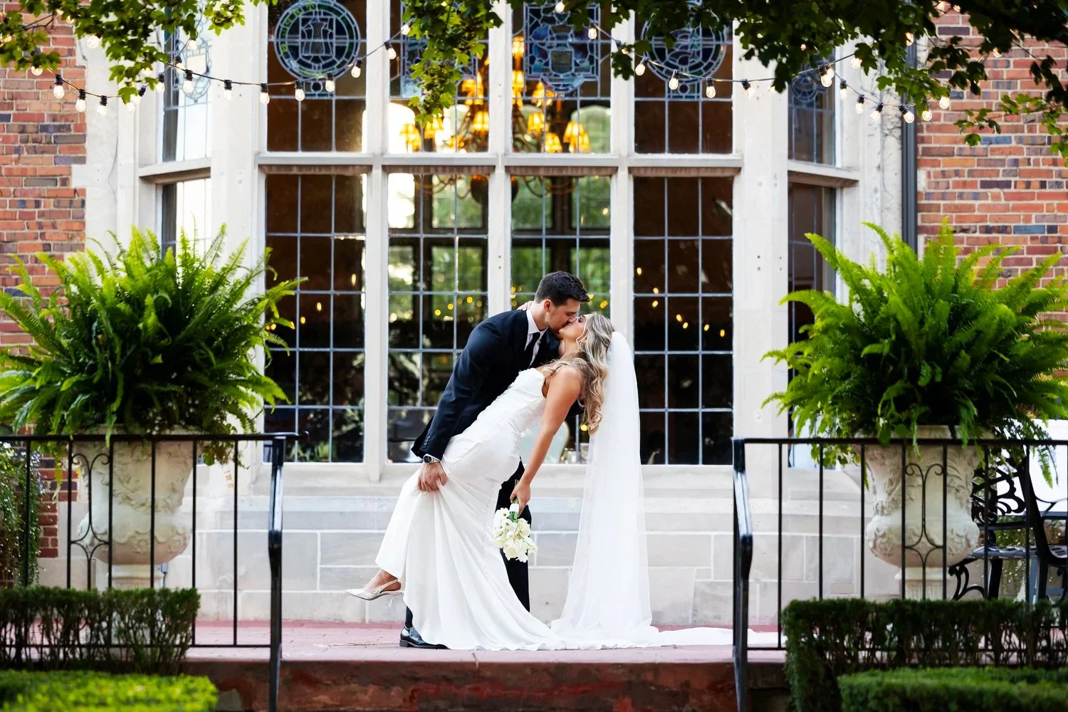 Bride and groom kissing outside of Pine Knob Mansion in Clarkston, Michigan