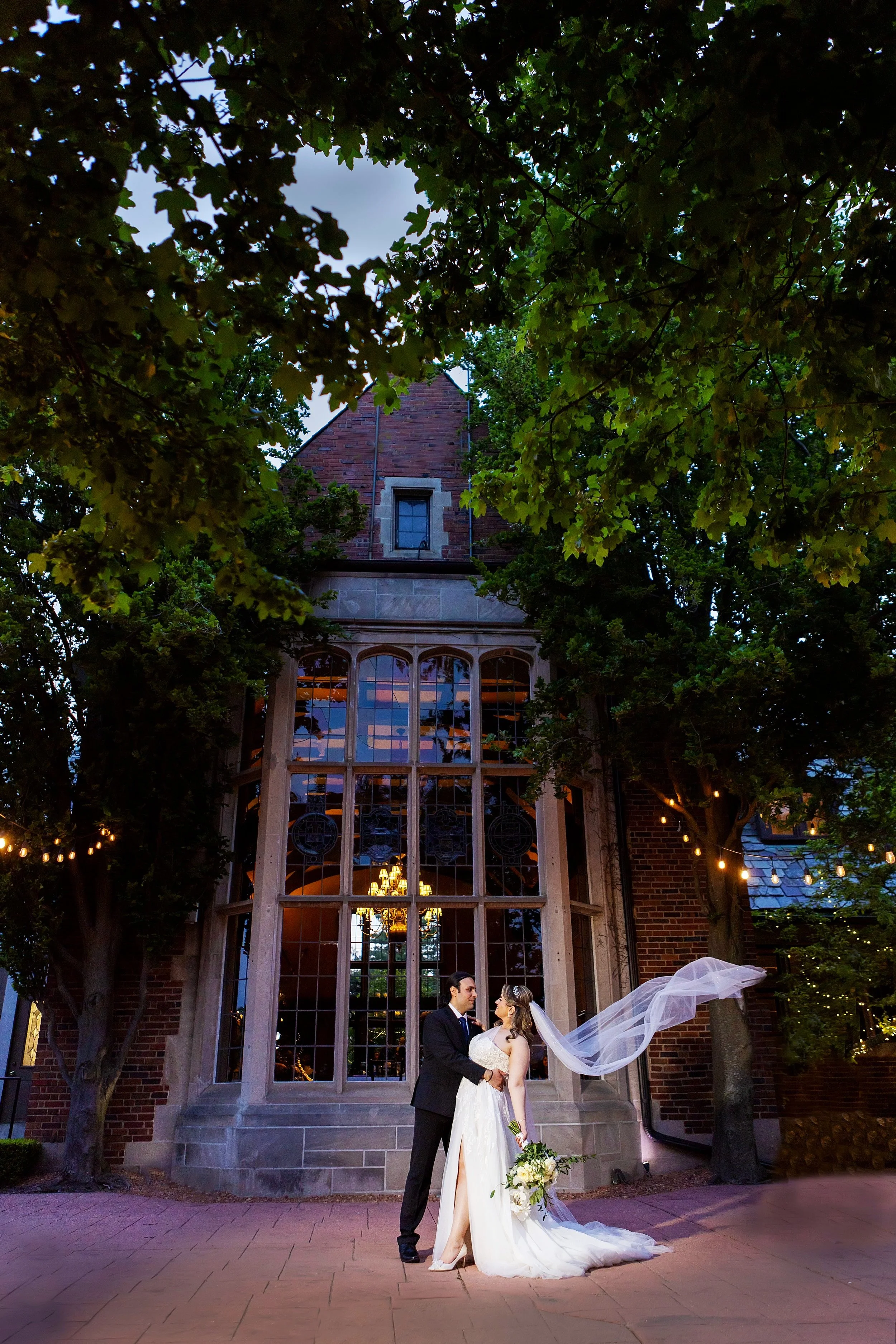 nighttime outdoor wedding photo of bride and groom at pine knob mansion in Clarkston, Michigan