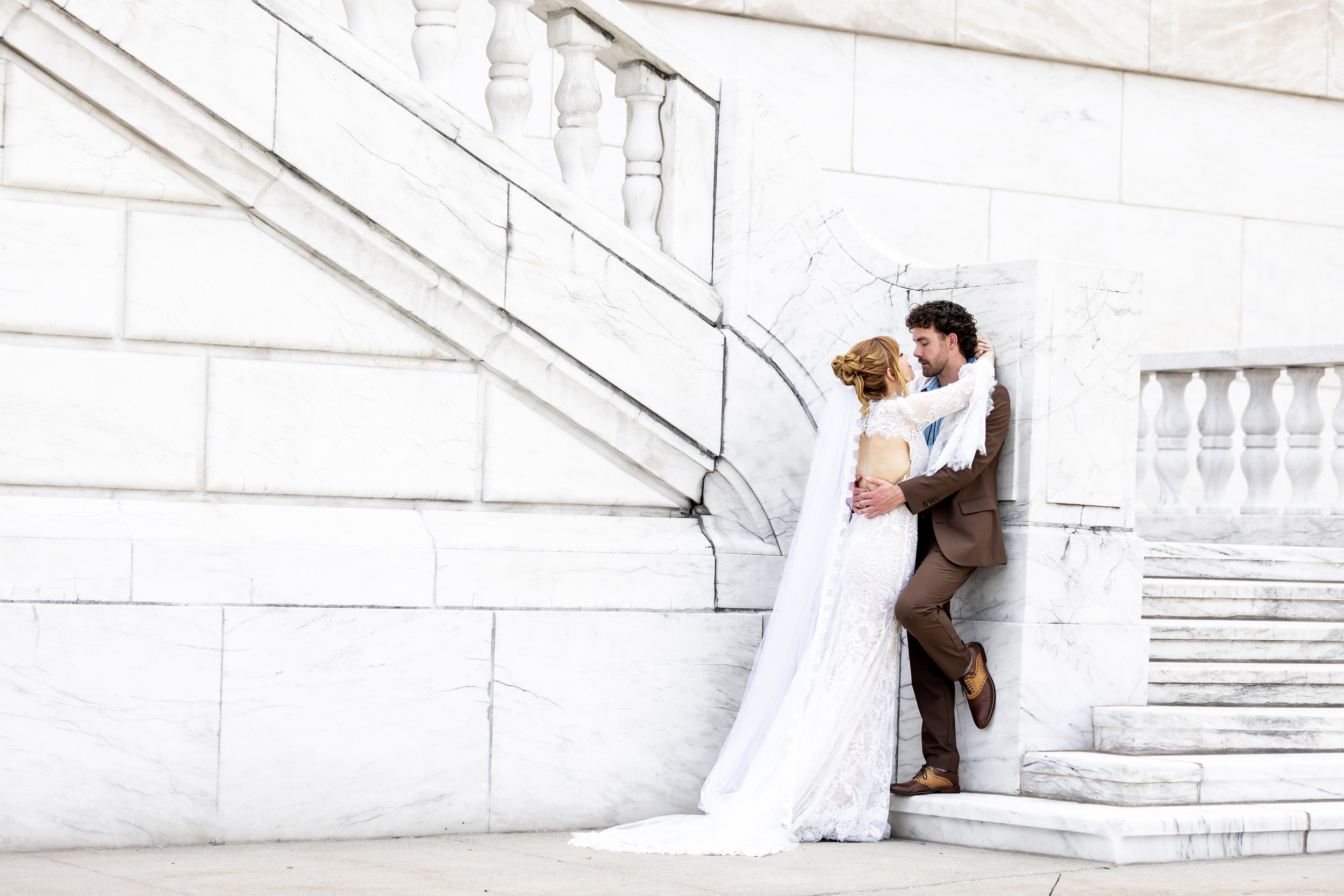 Bride and groom enjoying a relaxed and joyful moment outside The DIA after 12 hours of wedding photography, capturing their wedding day with timeless elegance.