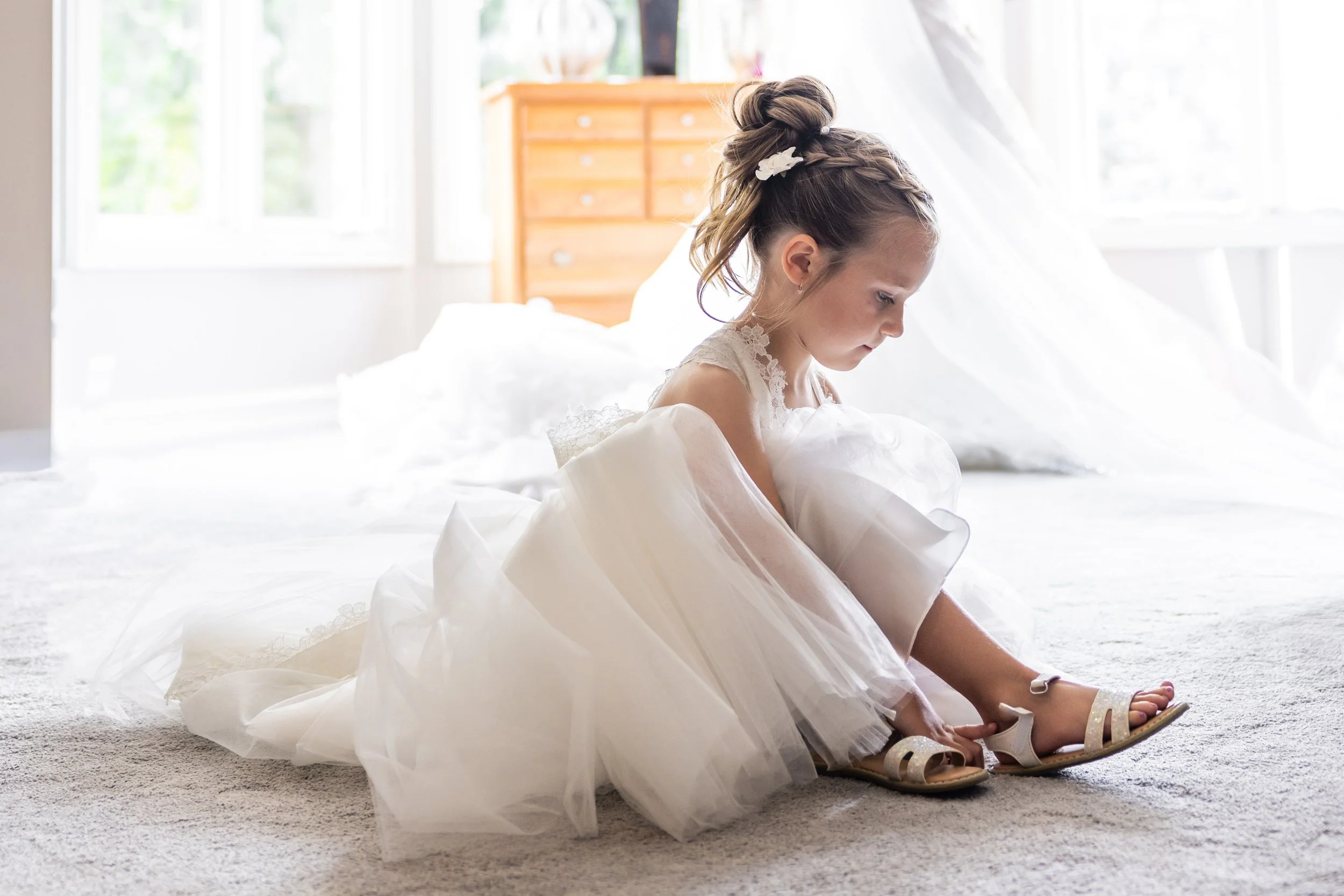 Flower Girl Putting On Shoes