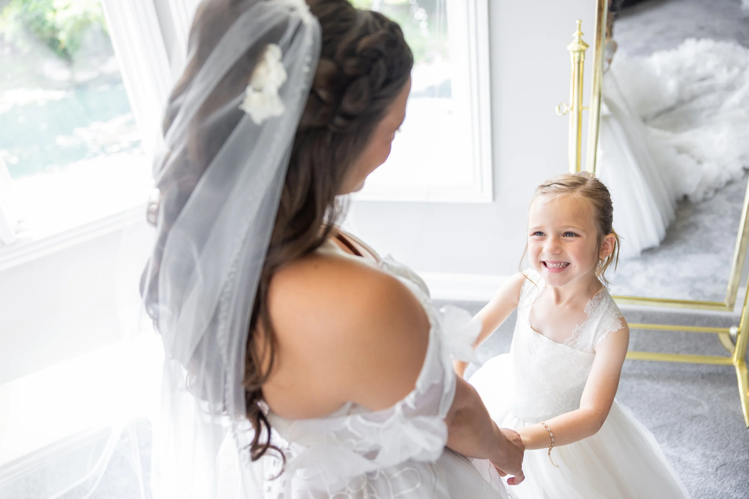 Flower Girl Smiling at Bride
