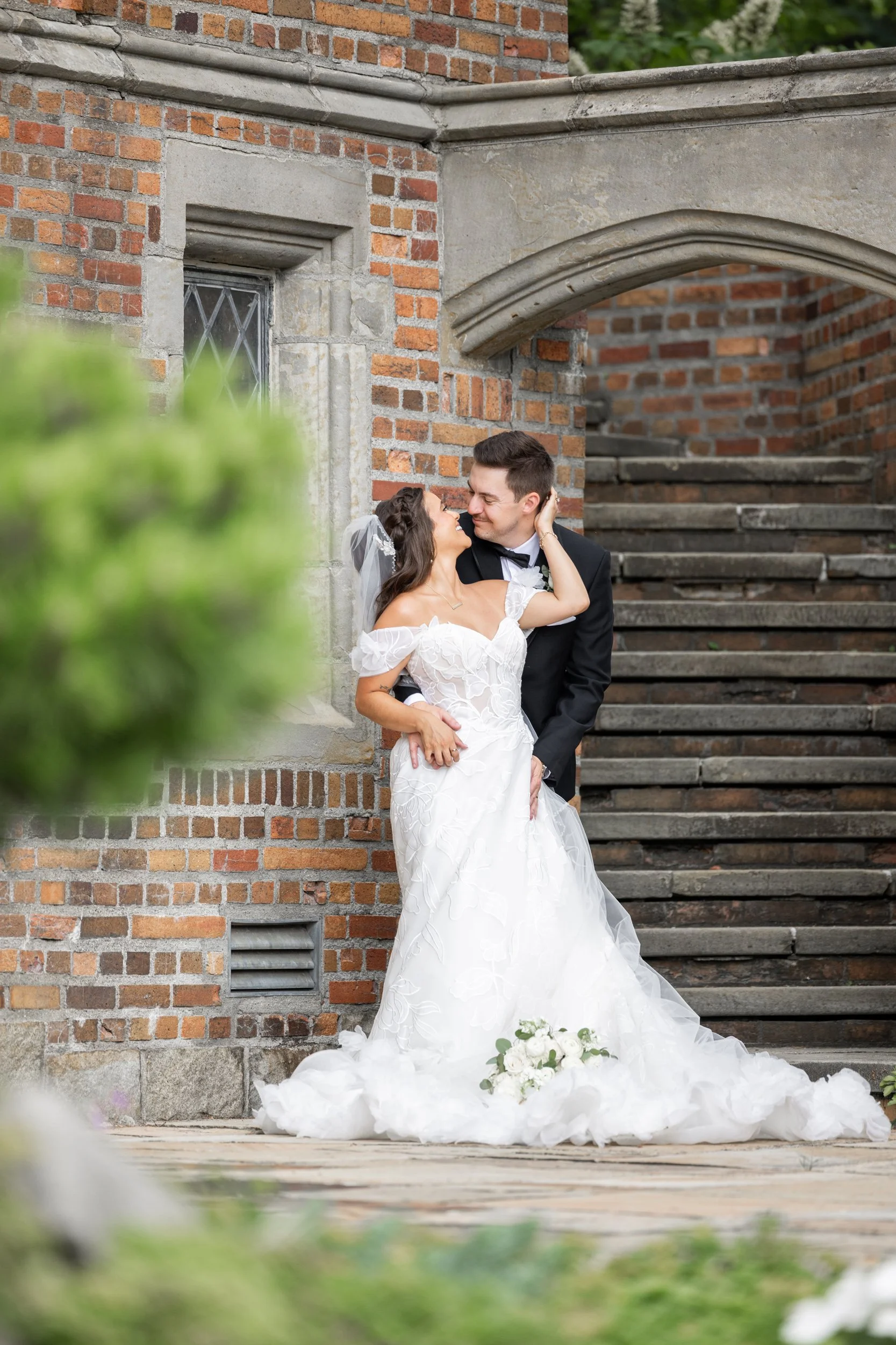 Bride and groom embrace outside Meadow Brook Hall in Rochester, Michigan