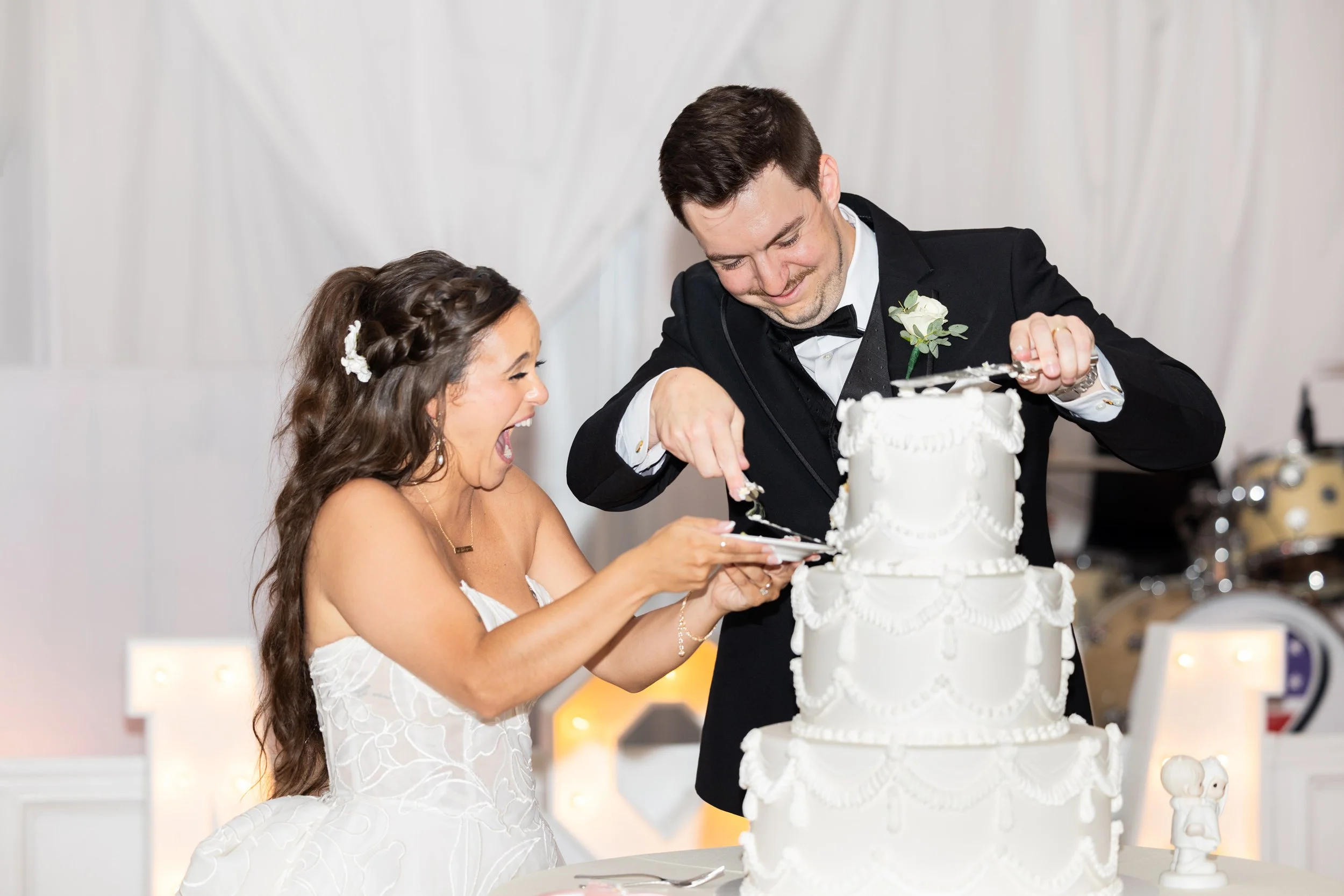 Bride and Groom Cutting Their Cake