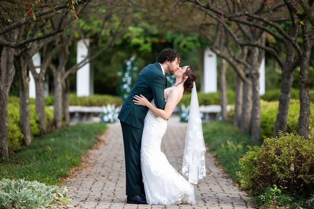 Bride and groom kiss at Weller's Weddings in Saline, Michigan