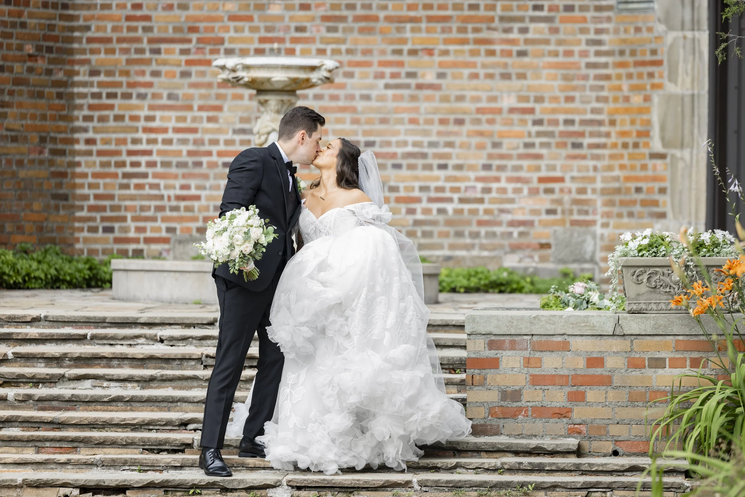 Bride and groom kissing at Meadow Brook Hall in Rochester, MI
