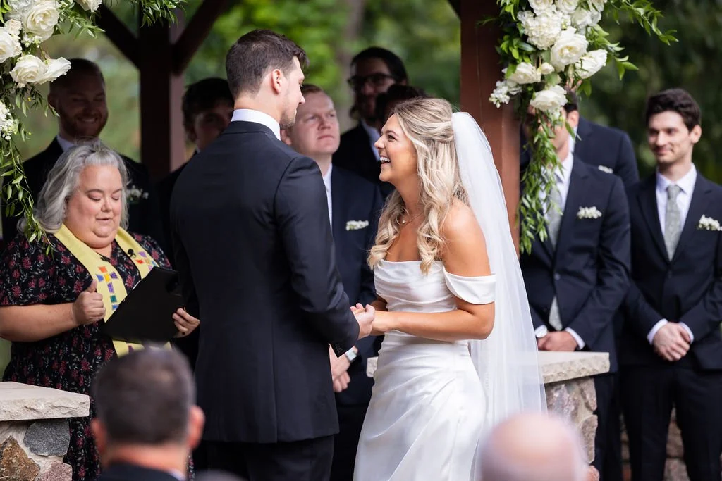 Bride and groom taking vows outside Pine Knob Mansion in Clarkston, MI