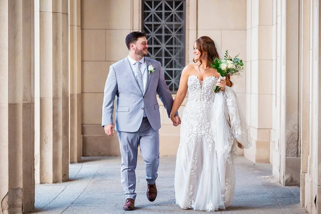 Bride and groom holding hands in downtown Jackson, Michigan