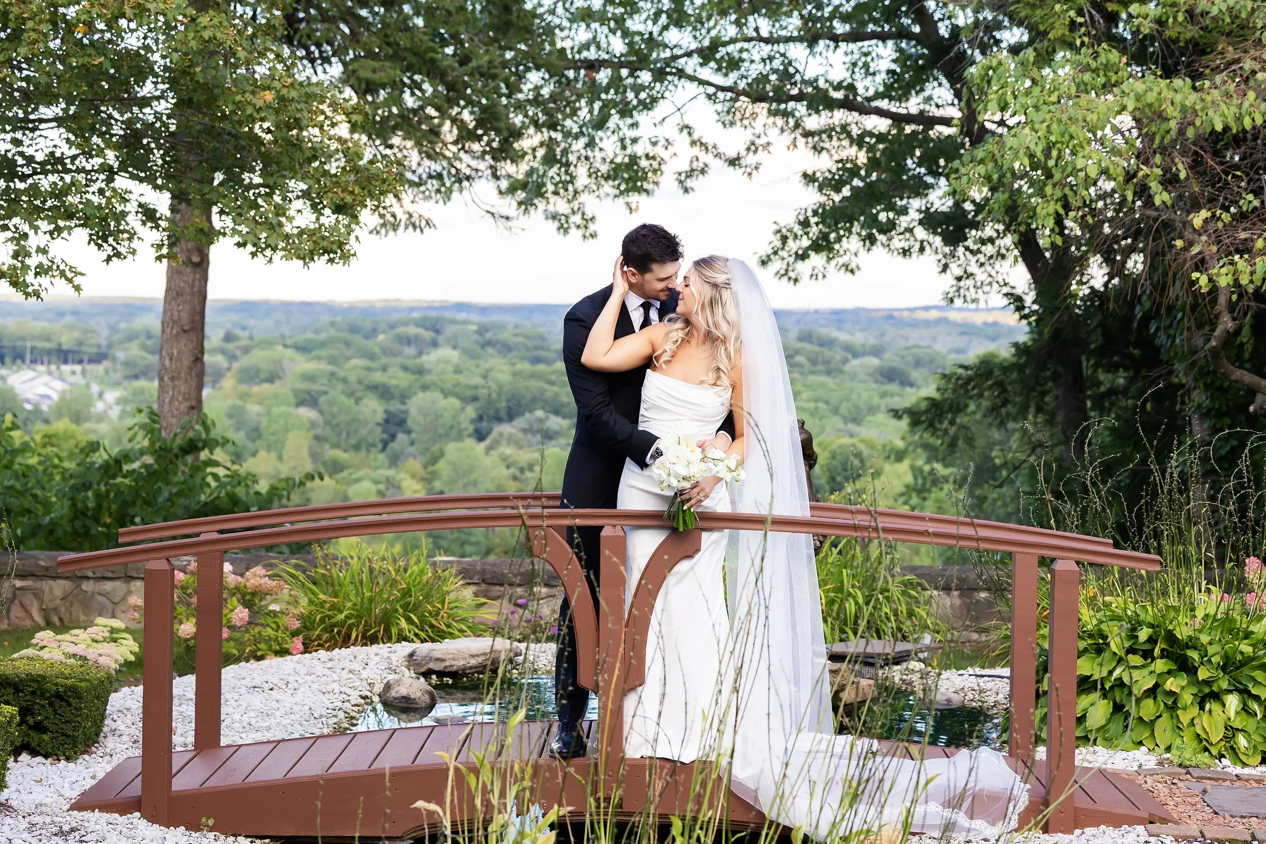 romantic photo of bride and groom together on bridge at Pine Knob Mansion in Clarkston, Michigan.