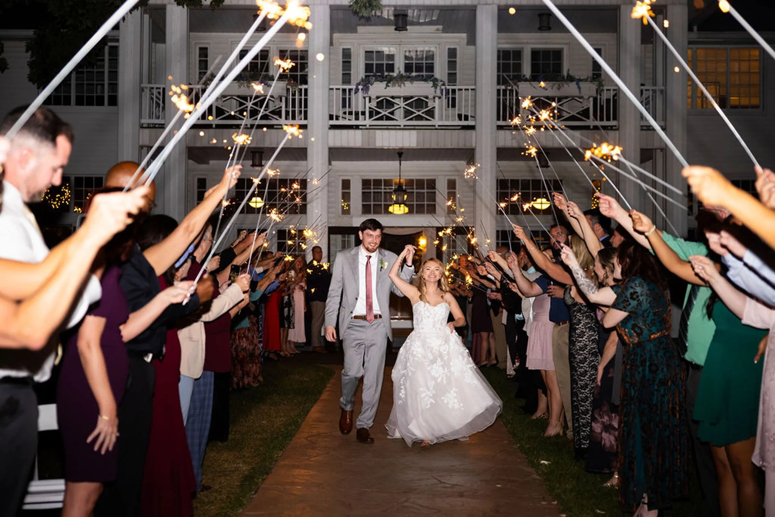 Bride and groom run though sparkler exit at Waldenwoods Resort in Howell, MI
