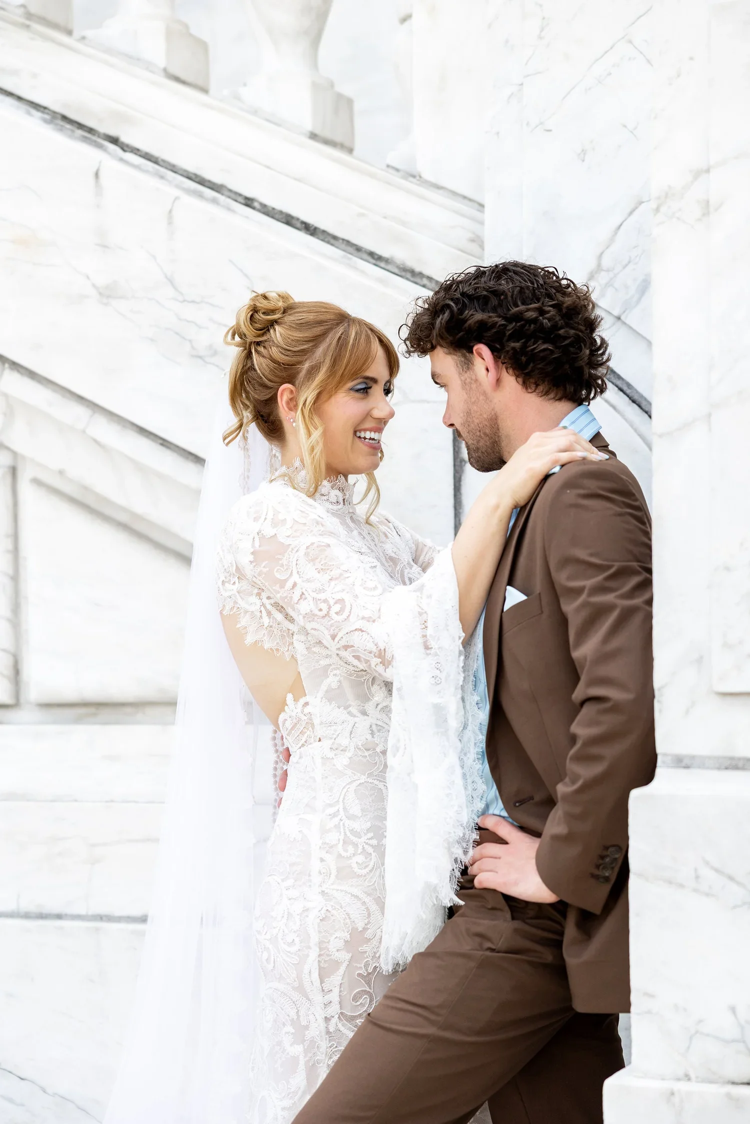 Bride and groom embrace at Detroit Institute of Arts
