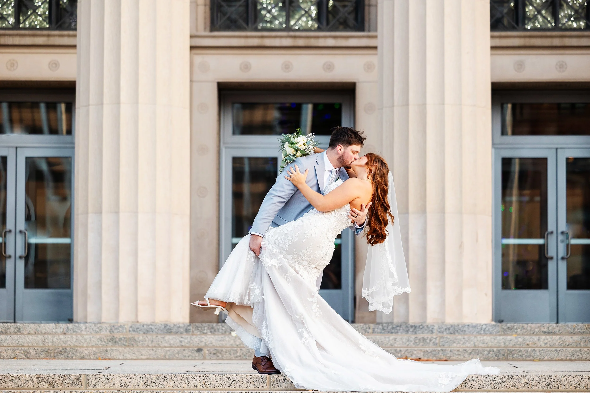 Bride and groom kissing in downtown Jackson, Michigan