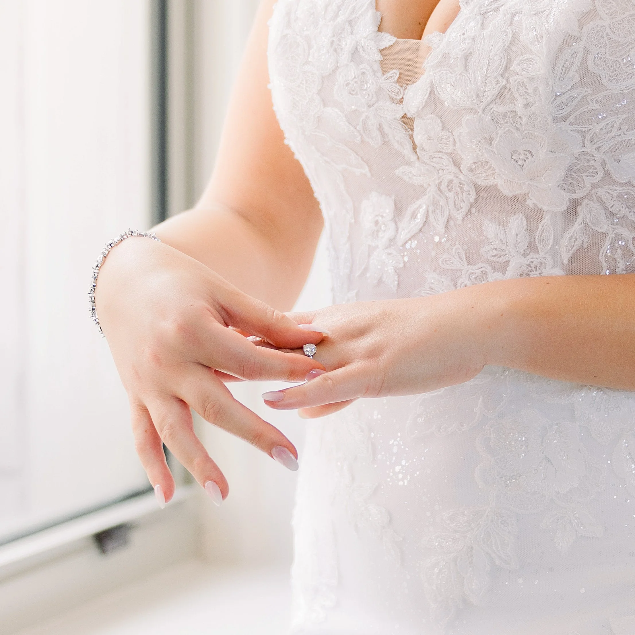 Close-up color photo of a bride adjusting her wedding ring before her Michigan wedding