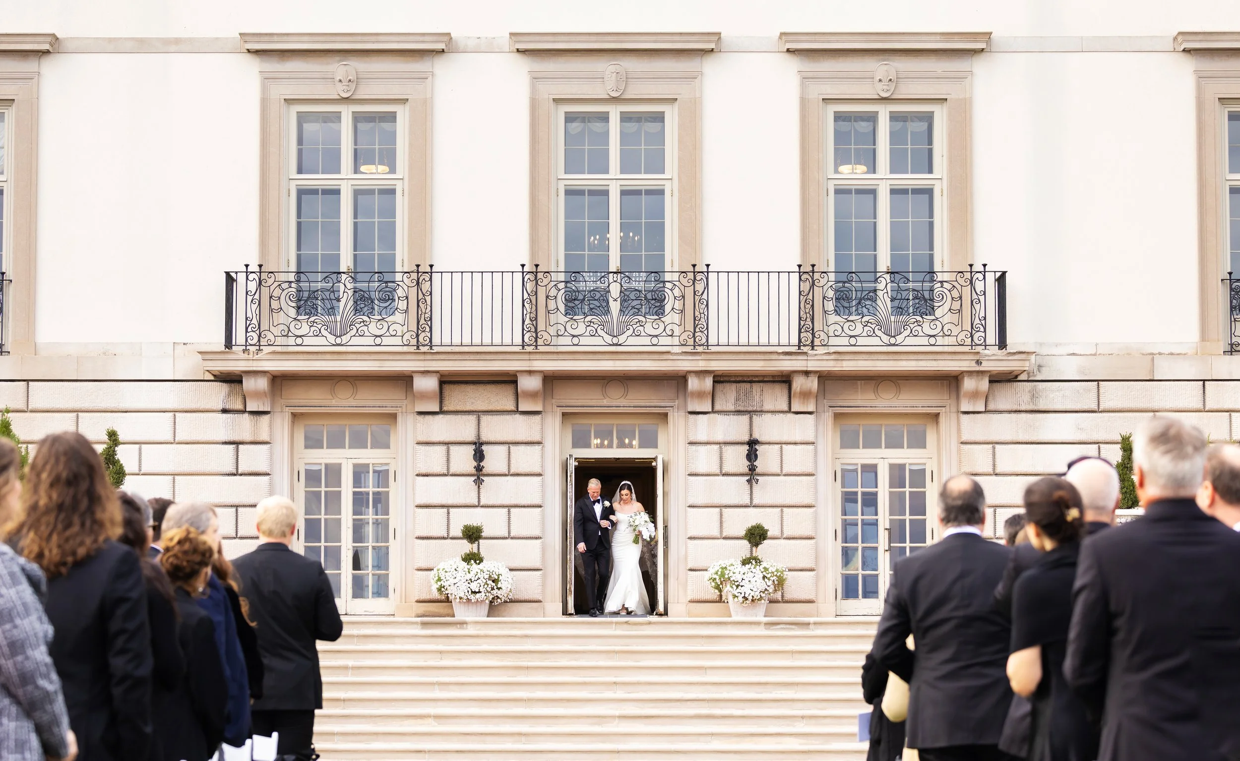 A dad walks his daughter down the aisle on her wedding day at Grosse Pointe War Memorial in Grosse Pointe Farms, Michigan