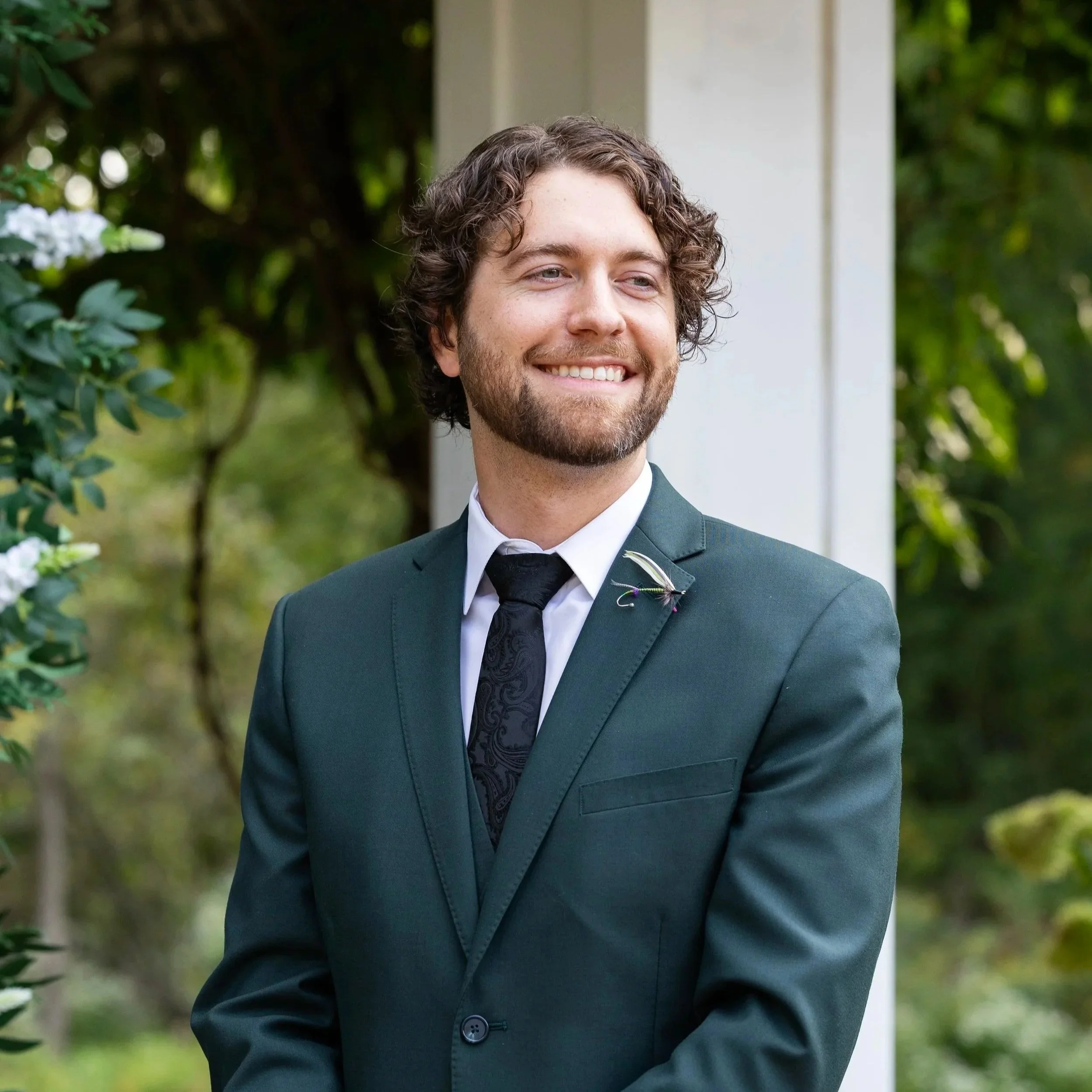 the groom smiles at his bride as she walks up the aisle at Wellers Weddings in Saline, Michigan