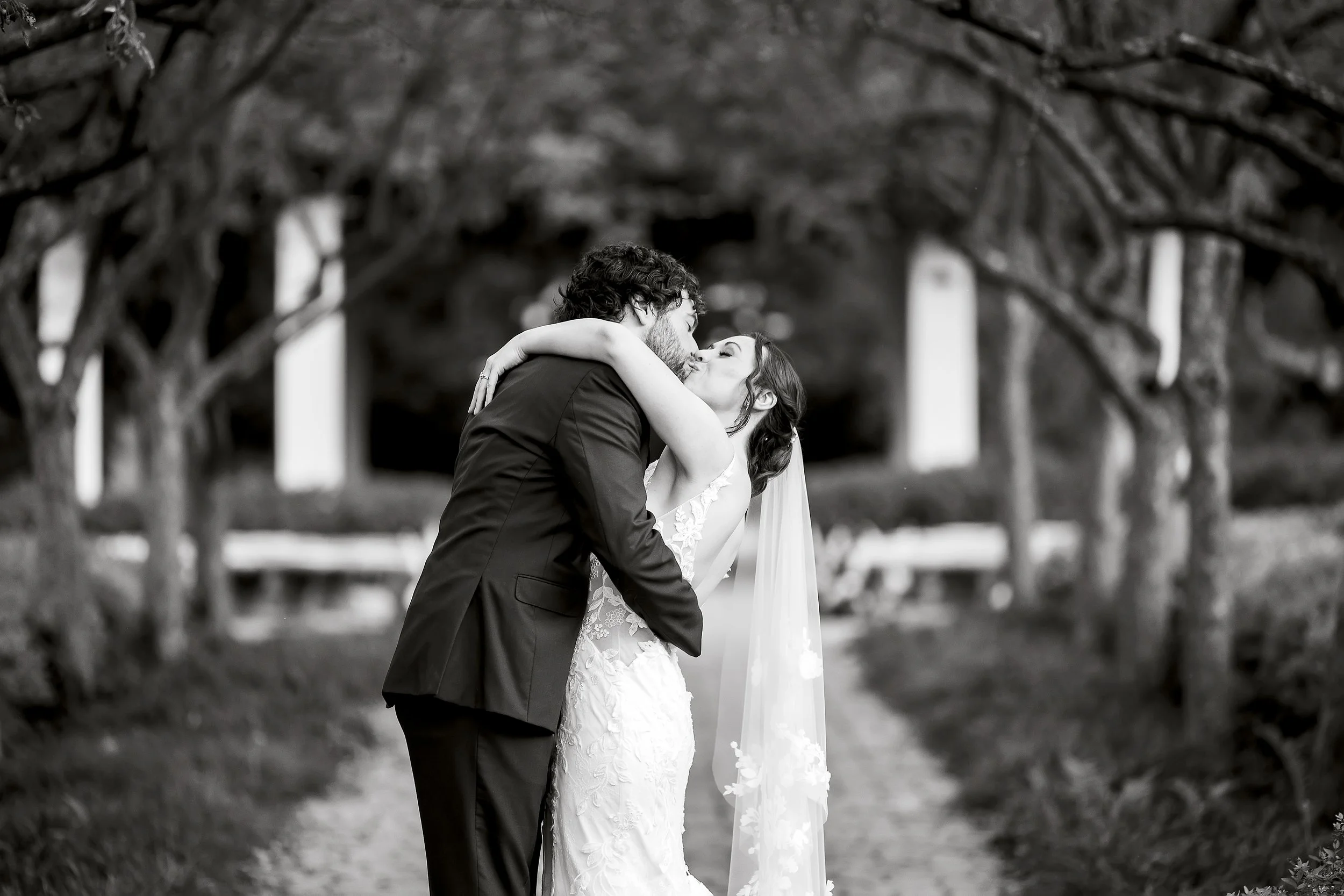 Groom kissing bride at Wellers Weddings in Saline, Michigan