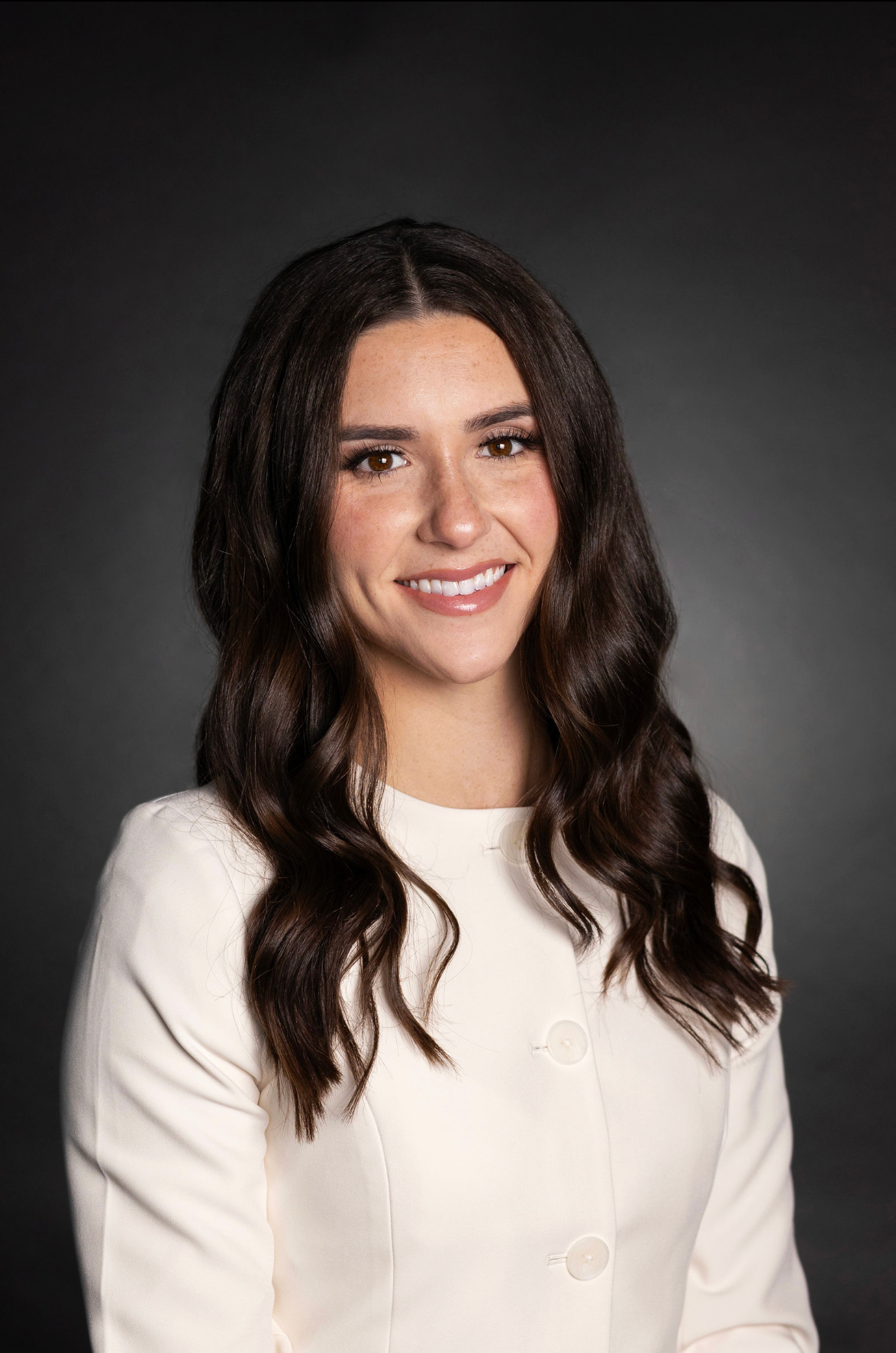 Woman smiling at the camera in a portrait studio