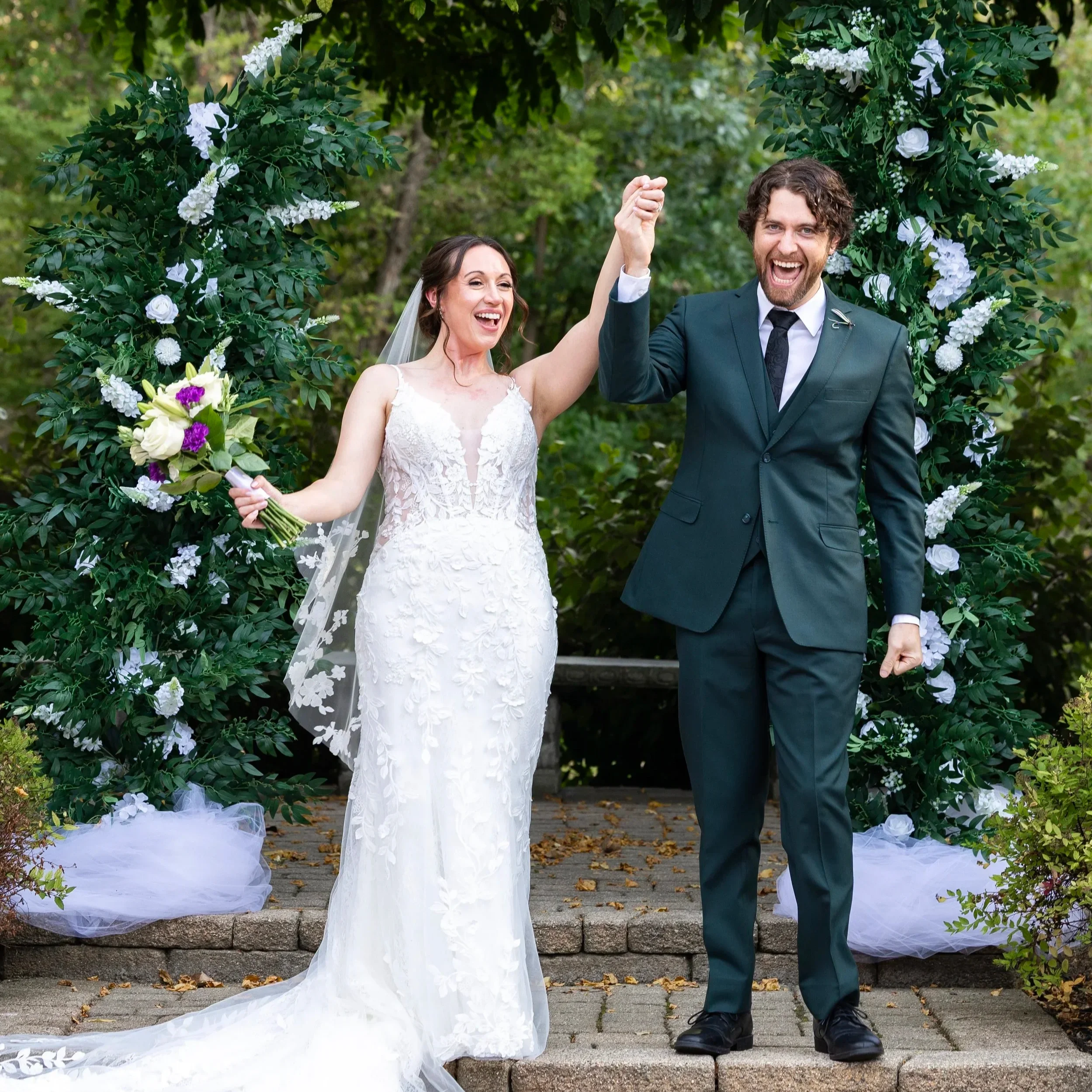 the bride and groom cheer after vows at ceremony at wellers weddings in saline michigan
