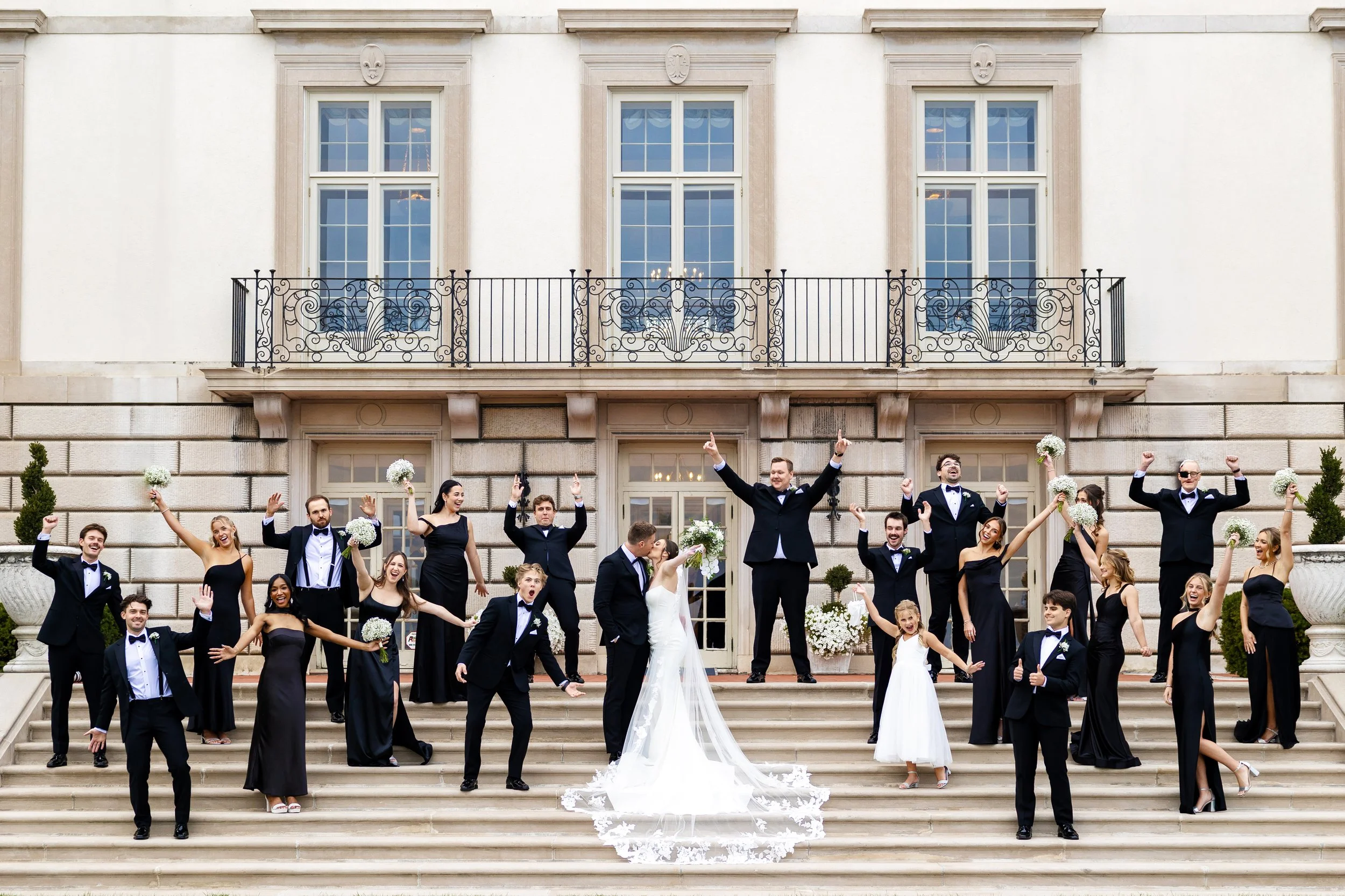 Large luxury wedding party posed on stairs of Grosse Pointe War Memorial in Grosse Pointe Farms, Michigan